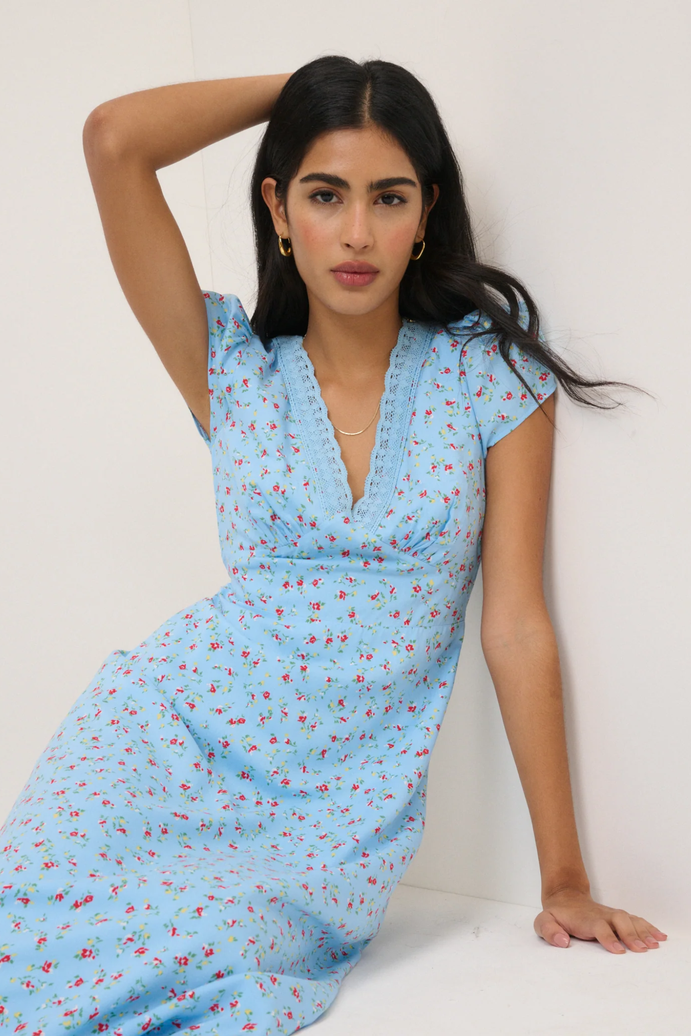 Woman wearing Nobody’s Child Kacey Blue Ditsy Floral Midi Dress by Nobody’s Child, shop the brand at Dotique online.