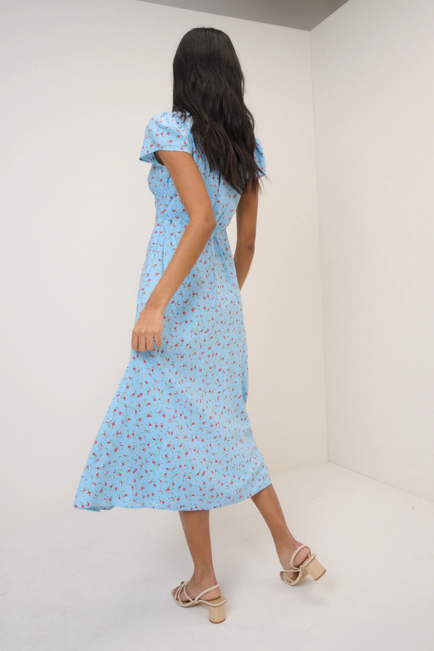 Woman wearing Nobody’s Child Kacey Blue Ditsy Floral Midi Dress by Nobody’s Child, shop the brand at Dotique online store.