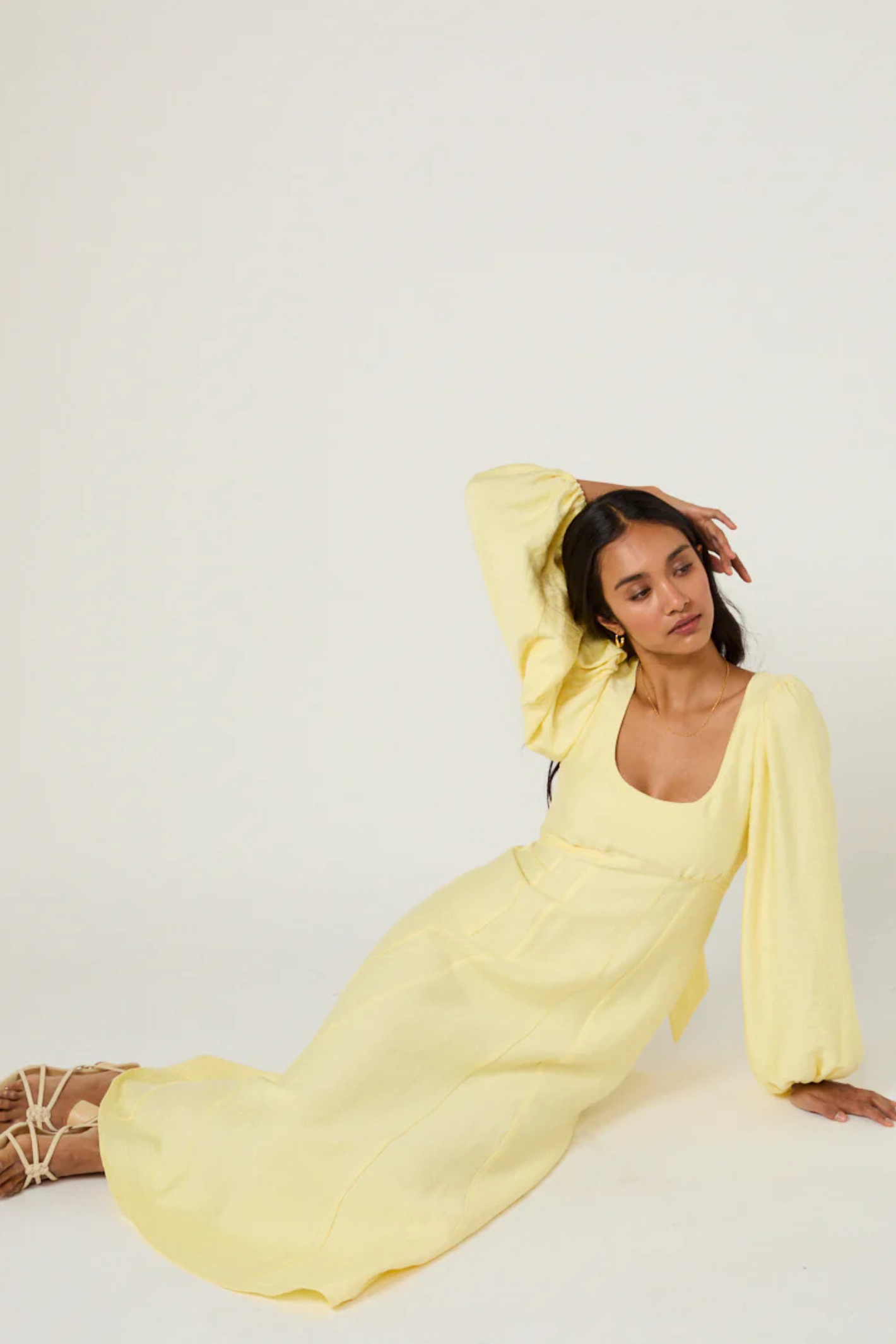 Nobody's Child Butter Yellow Bow Keyaa Midi Dress by nobody’s child worn seated with arm raised Shop nobody’s child at Dotique