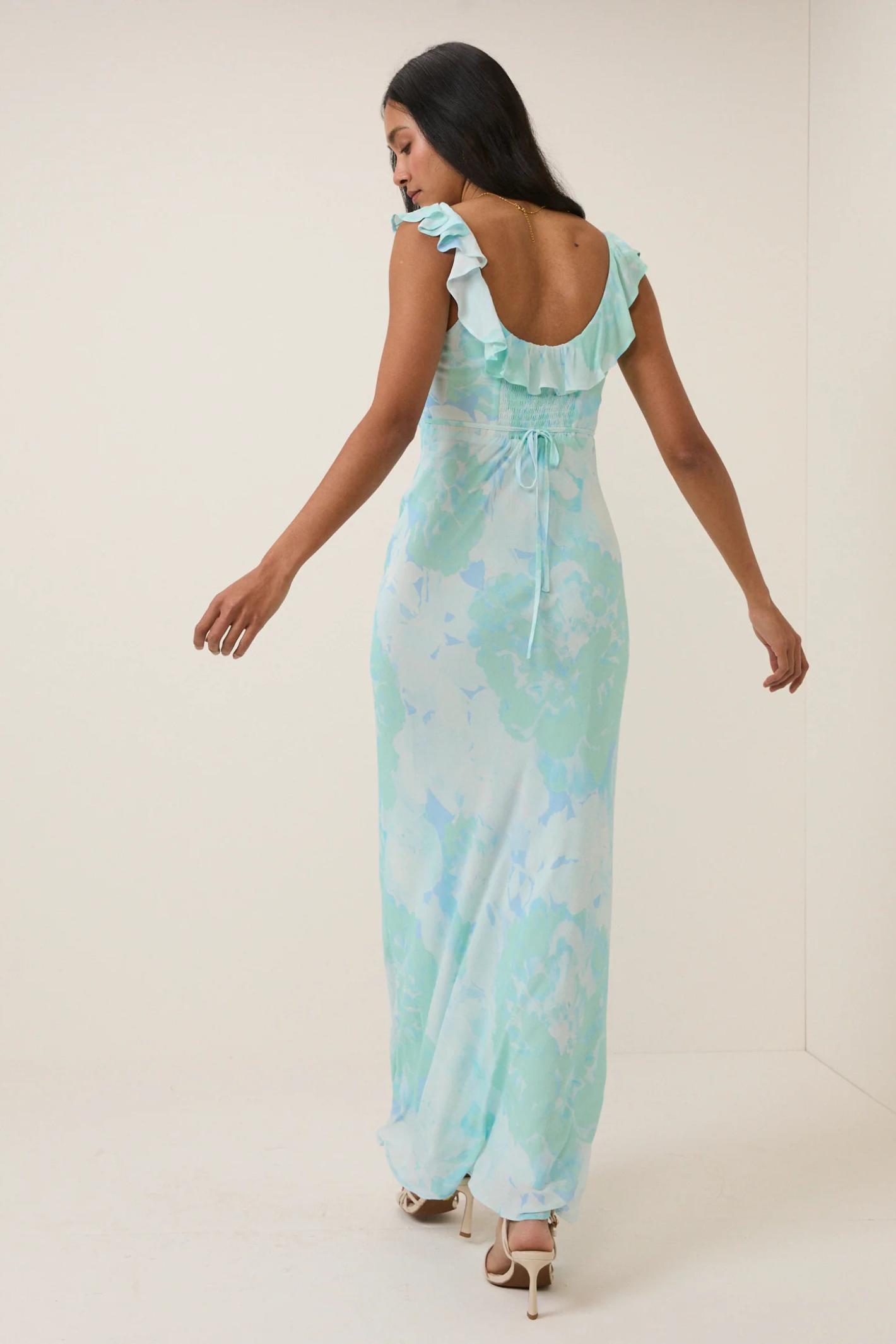 Woman wearing Nobody's Child Blue Floral Chiffon Logan Midi Dress by Nobody’s Child, shop the vendor at Dotique.