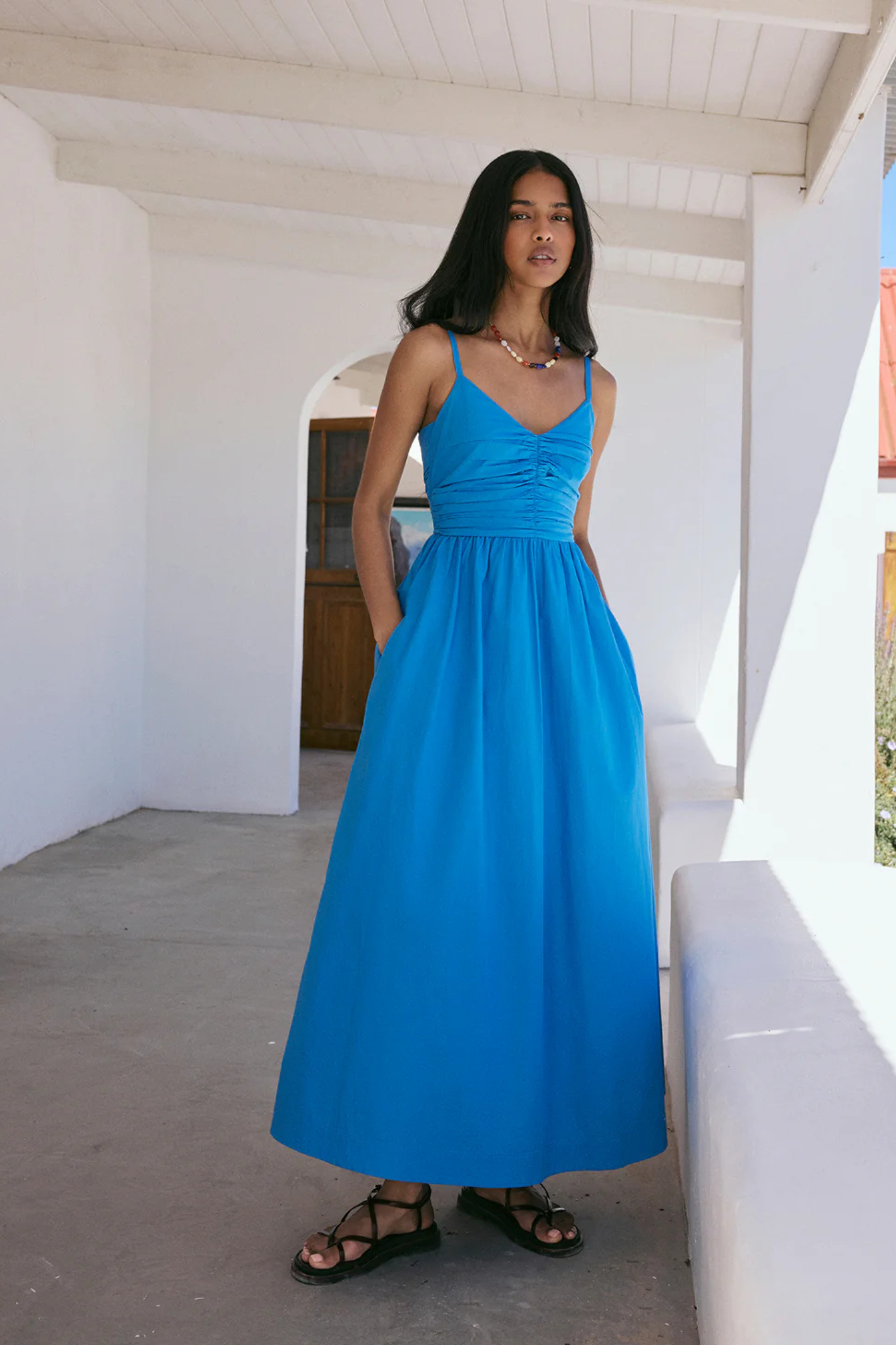 Woman wearing a blue Nobody's Child Paige Midi Dress by Nobody’s Child, available to shop at Dotique.