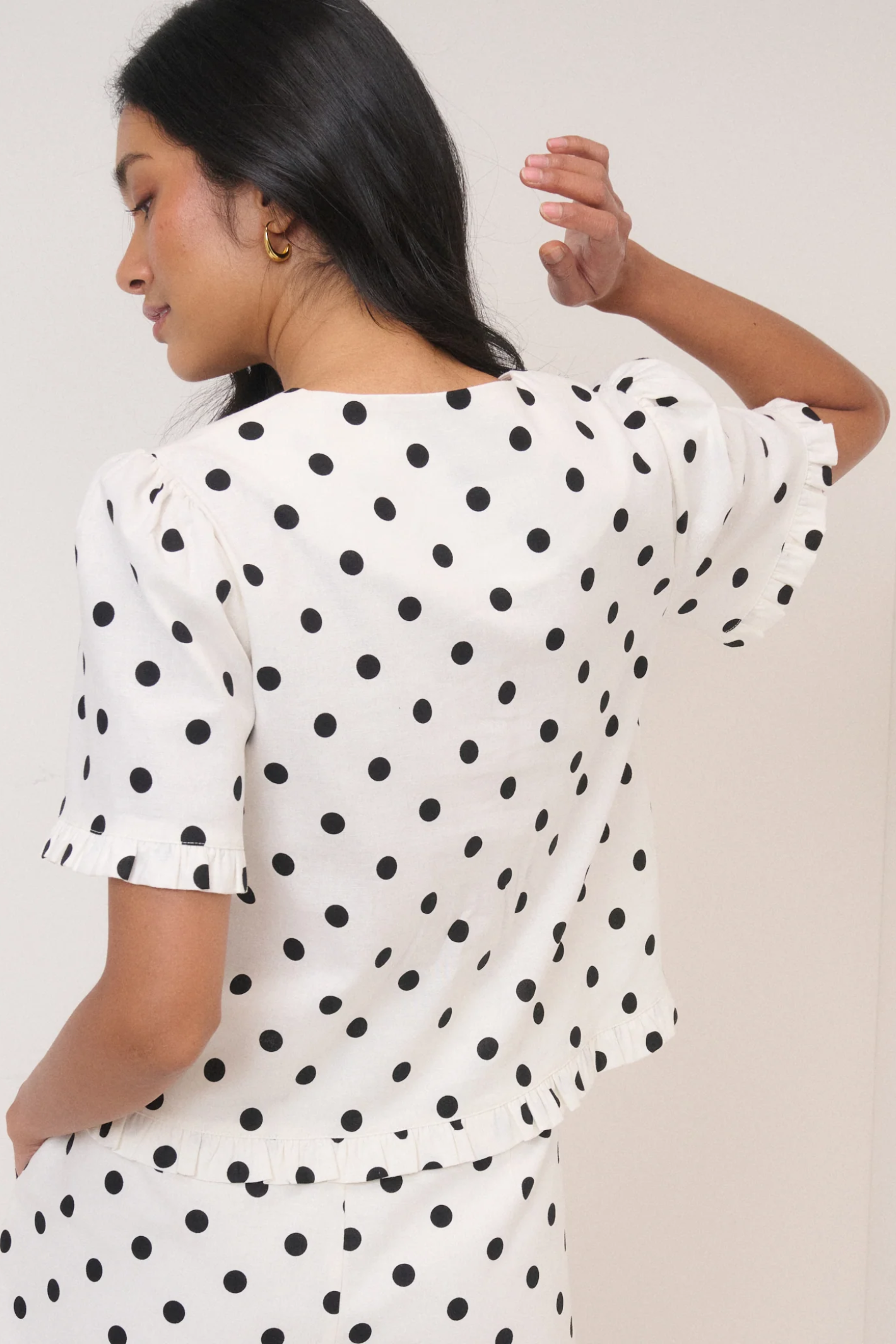 Woman wearing Nobody’s Child Ronne Frill Button Through Top Polka Dot by Nobody’s Child shop at Dotique in a stylish polka dot design