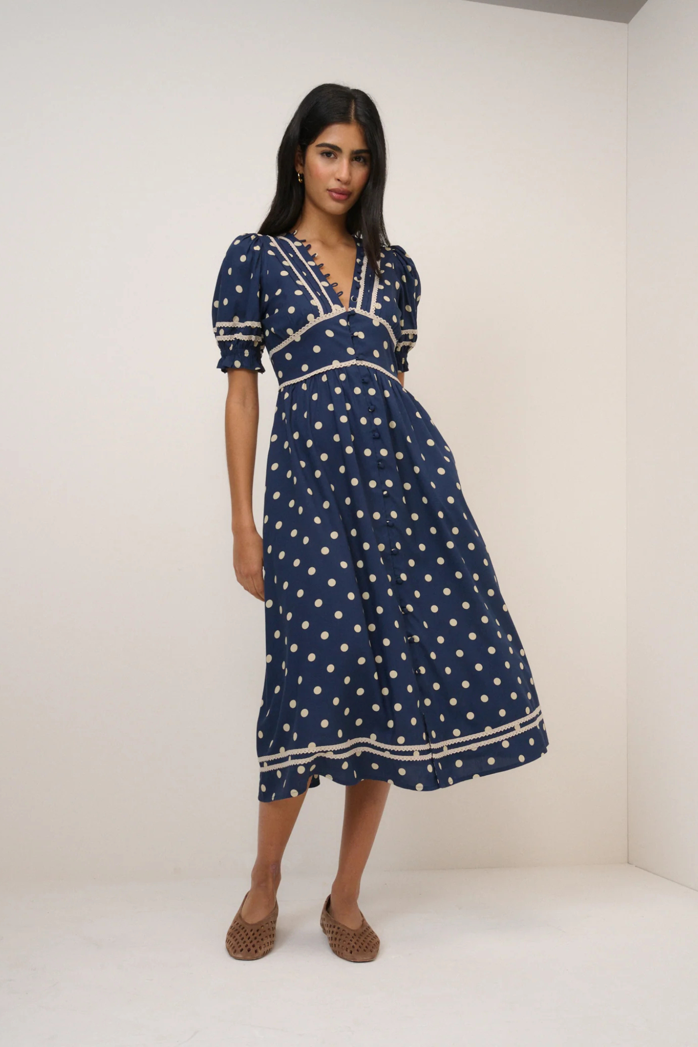 Nobody's Child Saffy Navy Polka Dot Midi Dress by nobody’s child styled with puff sleeves shown standing Shop nobody’s child at Dotique
