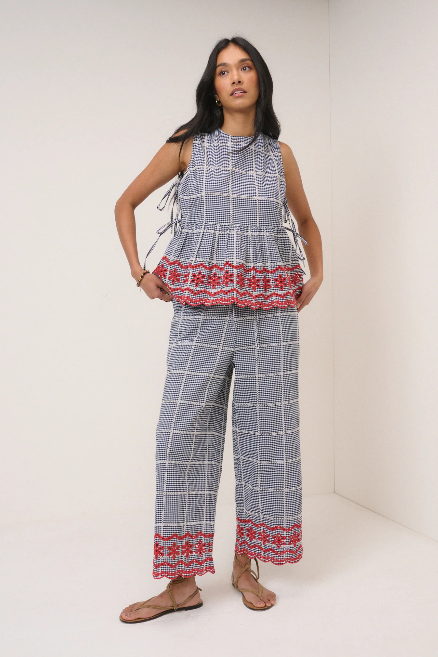 Model wearing Nobody's Child Shrew Embroidered Cropped Trousers Black Gingham by Nobody’s Child, shop at Dotique.