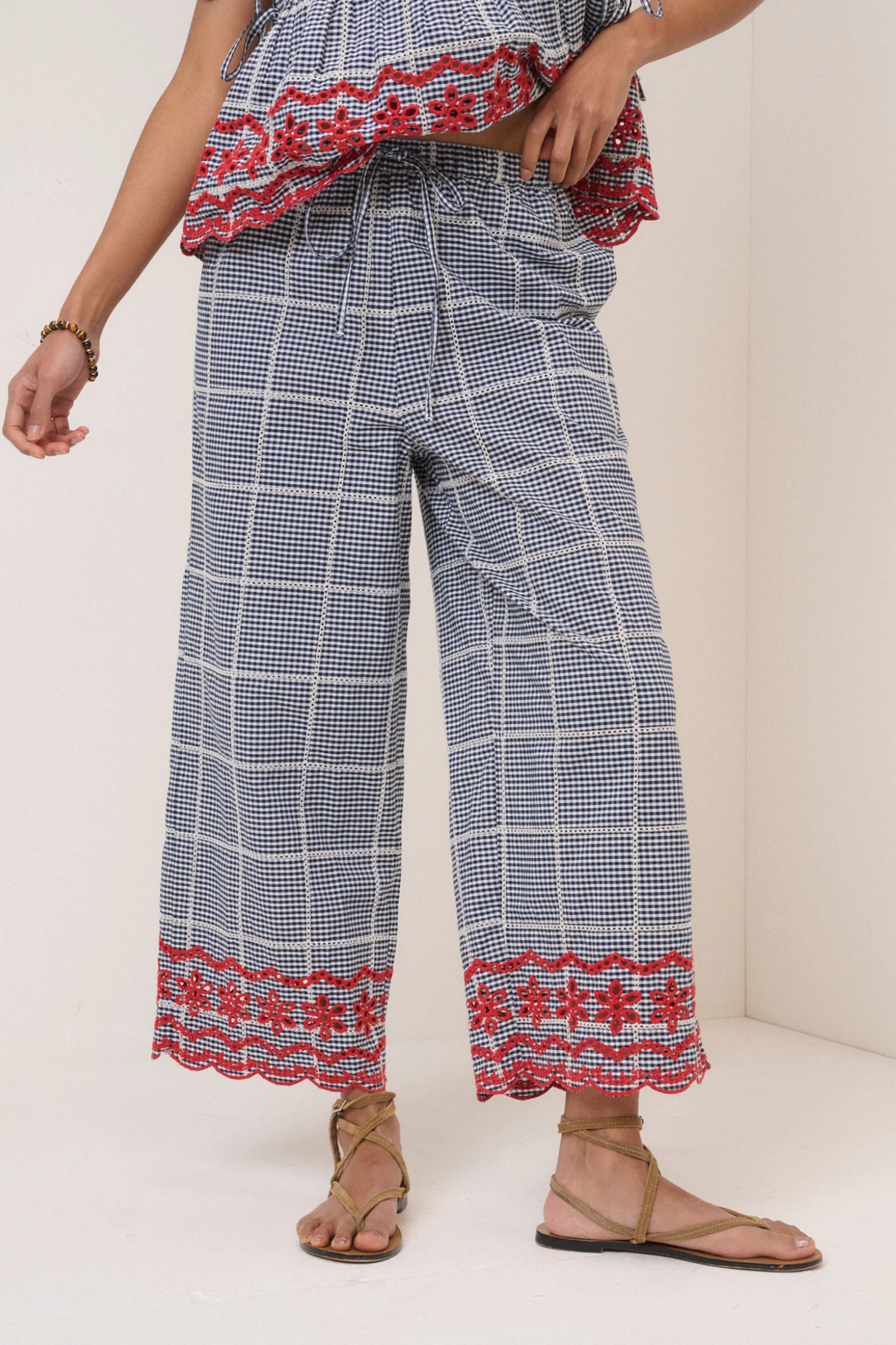 Model wearing Nobody's Child Shrew Embroidered Cropped Trousers Black Gingham by Nobody’s Child, shop at Dotique.
