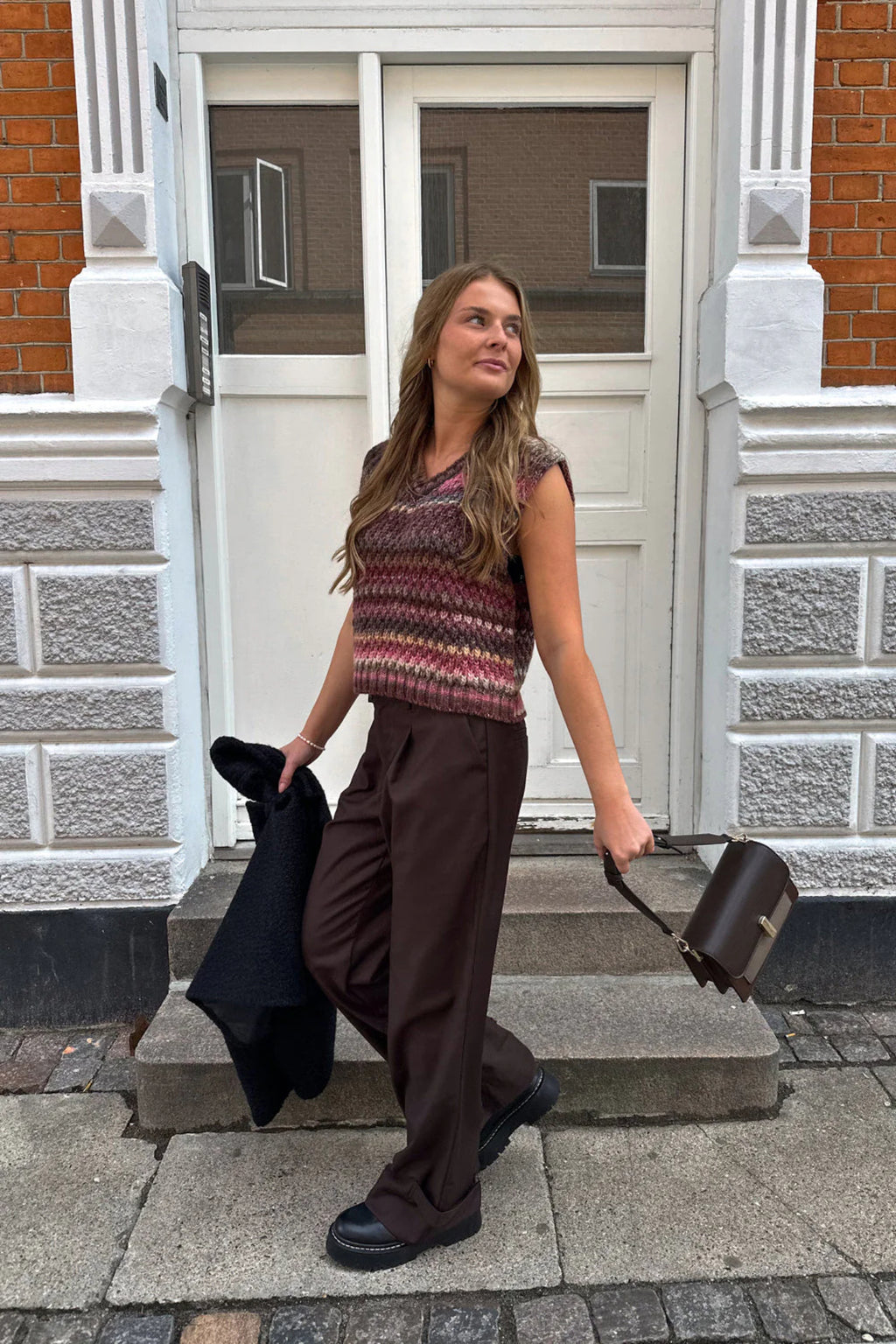 The Noella Gio Knit Vest in Rust Mix brings all the warmth and character of autumn dressing into one beautifully textured piece. Shop Noella at Dotique.