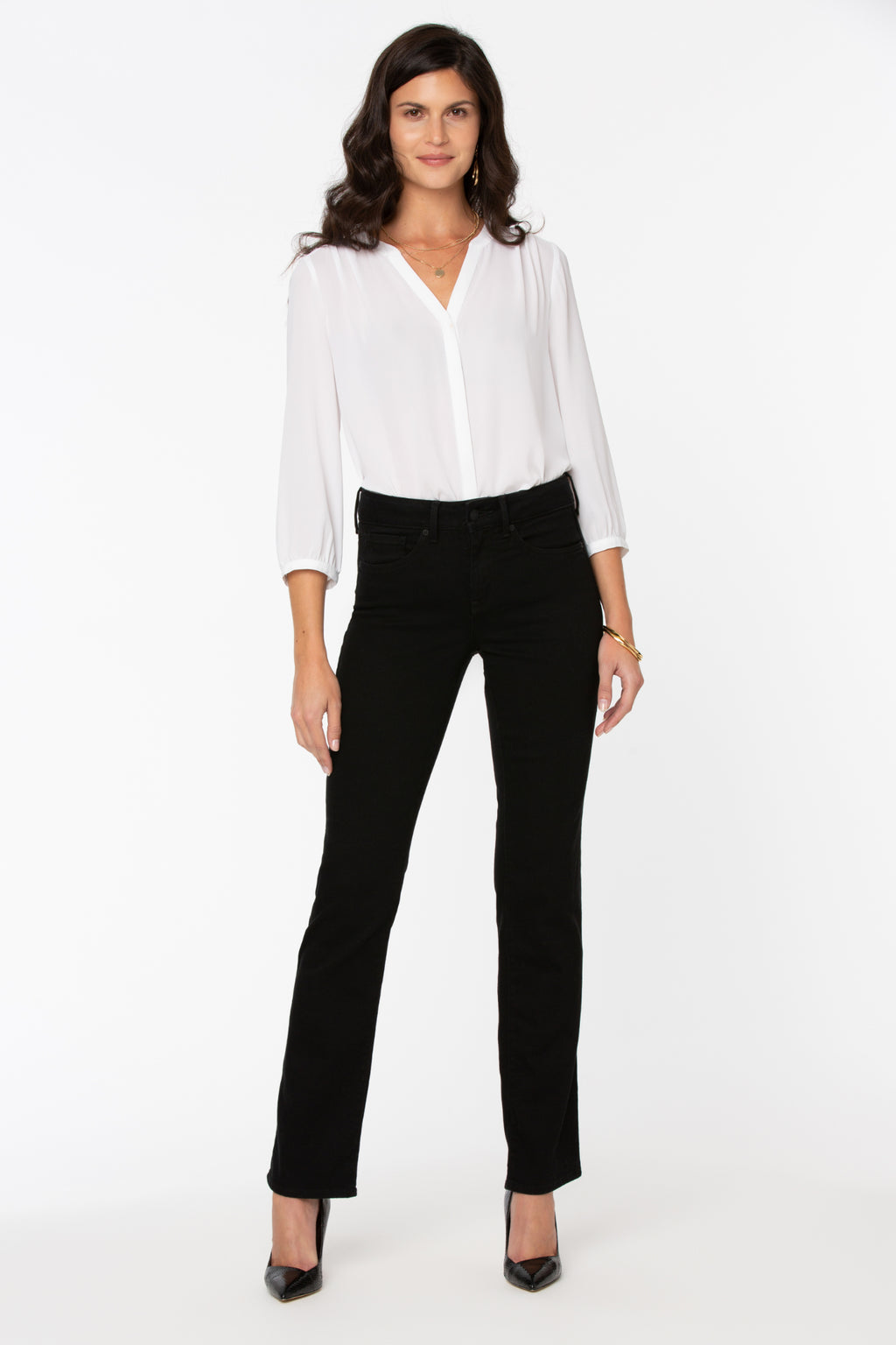 Model wearing NYDJ Barbara Bootcut Black Jeans 30” styled with a white blouse, shop NYDJ at Dotique.
