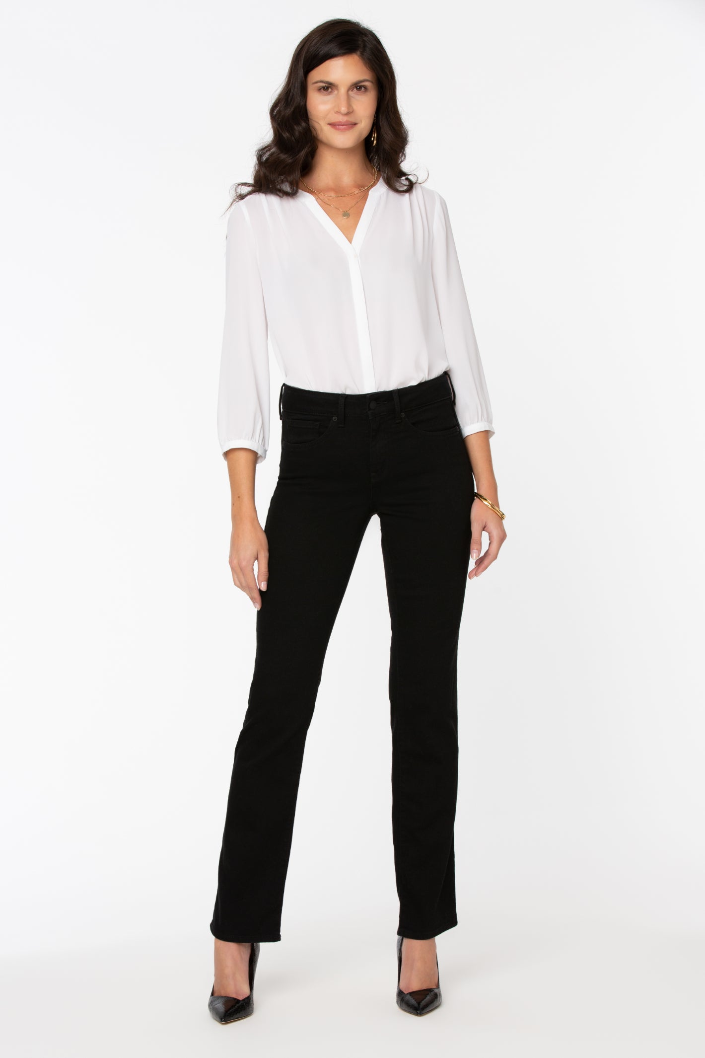 Model wearing NYDJ Barbara Bootcut Black Jeans 30” styled with a white blouse, shop NYDJ at Dotique.