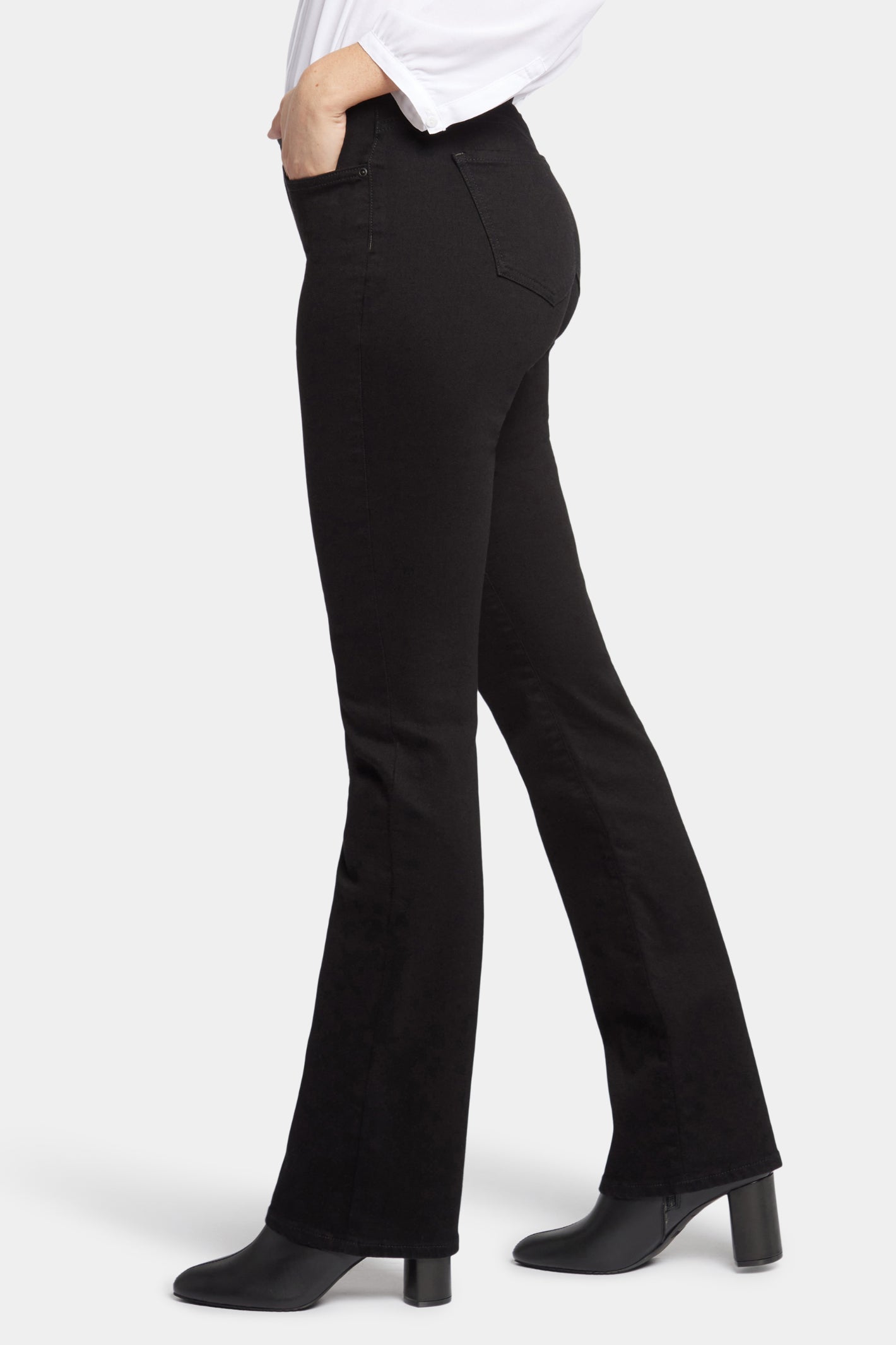 Side view of a model wearing NYDJ Barbara Bootcut Black Jeans 30” by NYDJ, shop the NYDJ collection at Dotique.