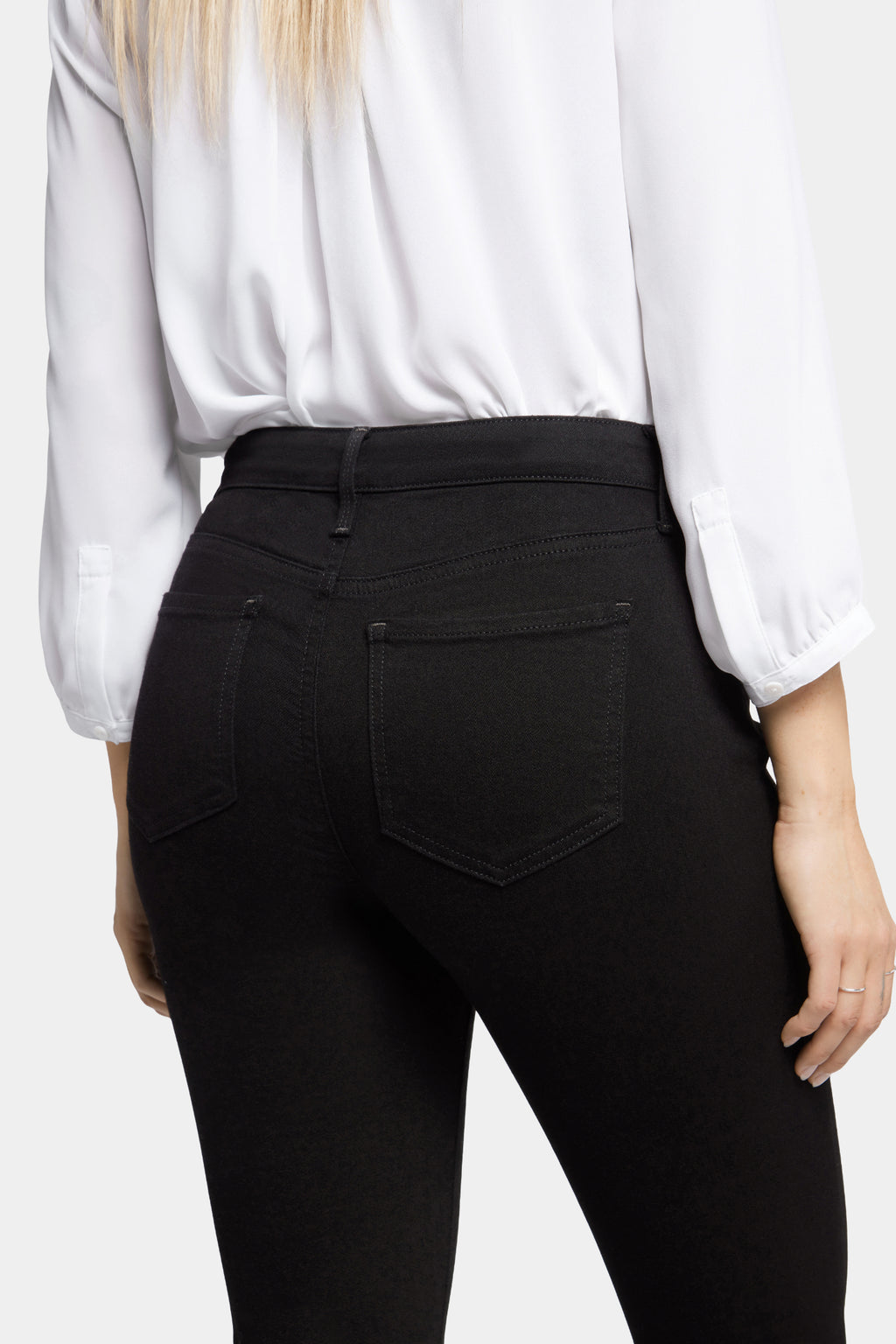 Woman wearing NYDJ Barbara Bootcut Black Jeans 30” by NYDJ from the back, shop NYDJ at Dotique.