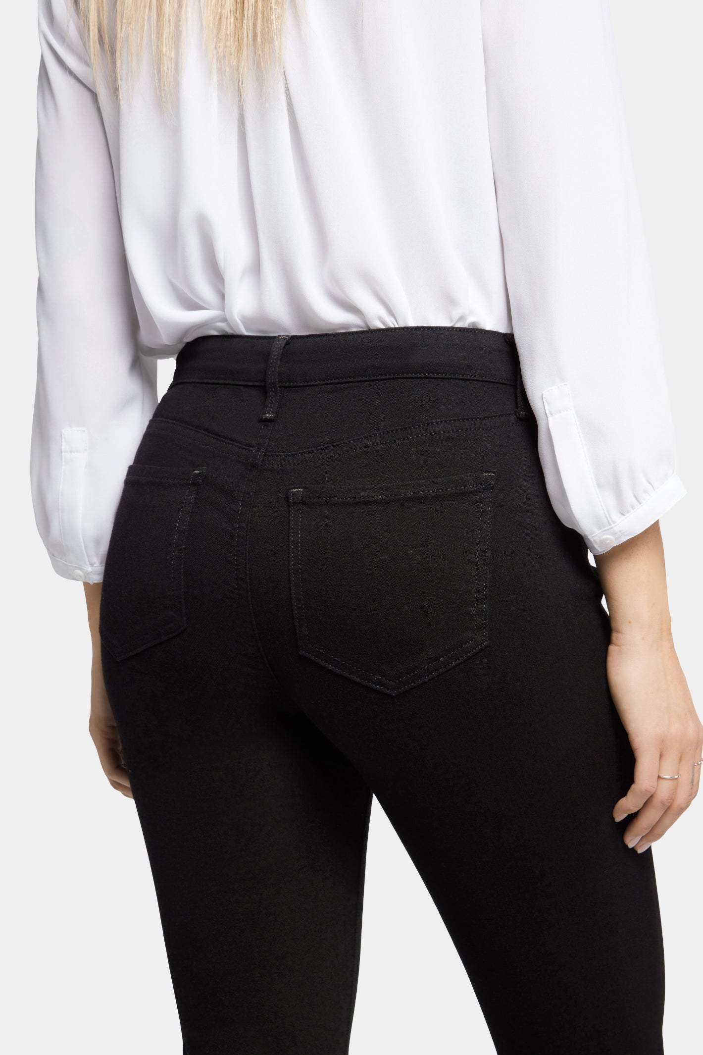 Woman wearing NYDJ Barbara Bootcut Black Jeans 30” by NYDJ from the back, shop NYDJ at Dotique.