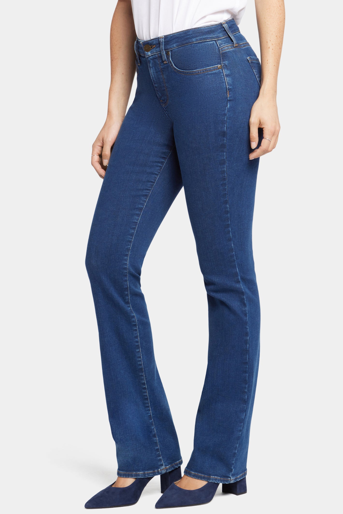 Woman wearing NYDJ Barbara Bootcut Quinn Jeans 30” in blue denim, shop the NYDJ collection at Dotique.