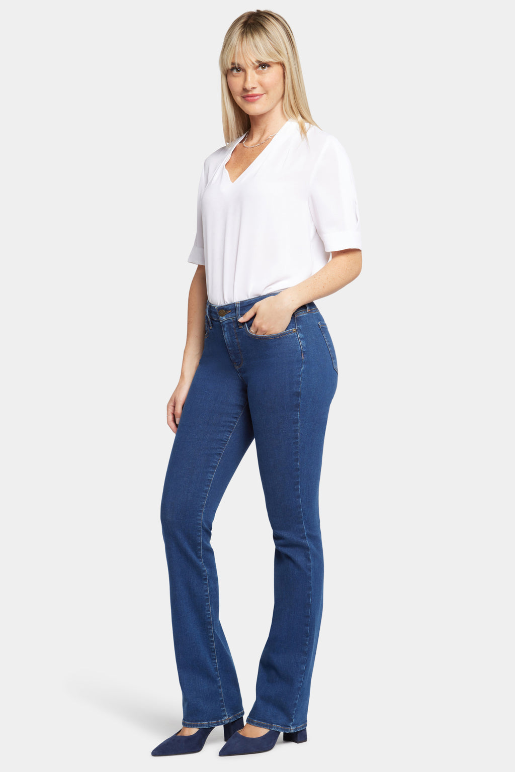 Woman wearing NYDJ Barbara Bootcut Quinn Jeans 30” paired with white blouse, shop NYDJ at Dotique for stylish denim.
