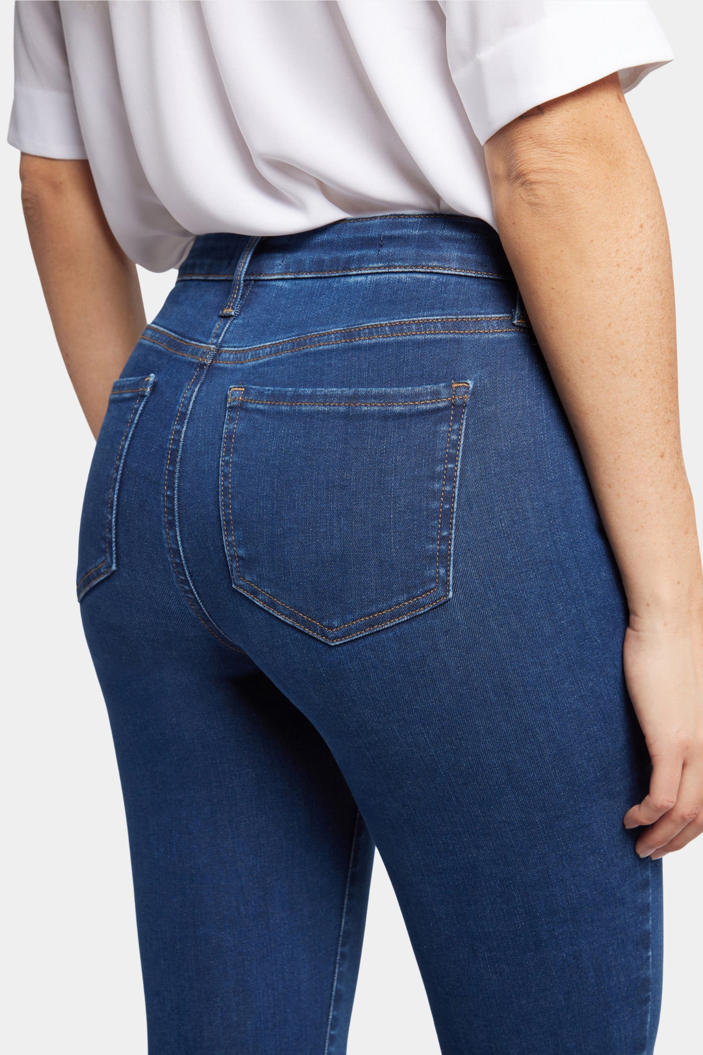 Close-up of a woman wearing NYDJ Barbara Bootcut Quinn Jeans 30” by NYDJ, shop NYDJ at Dotique for stylish denim.