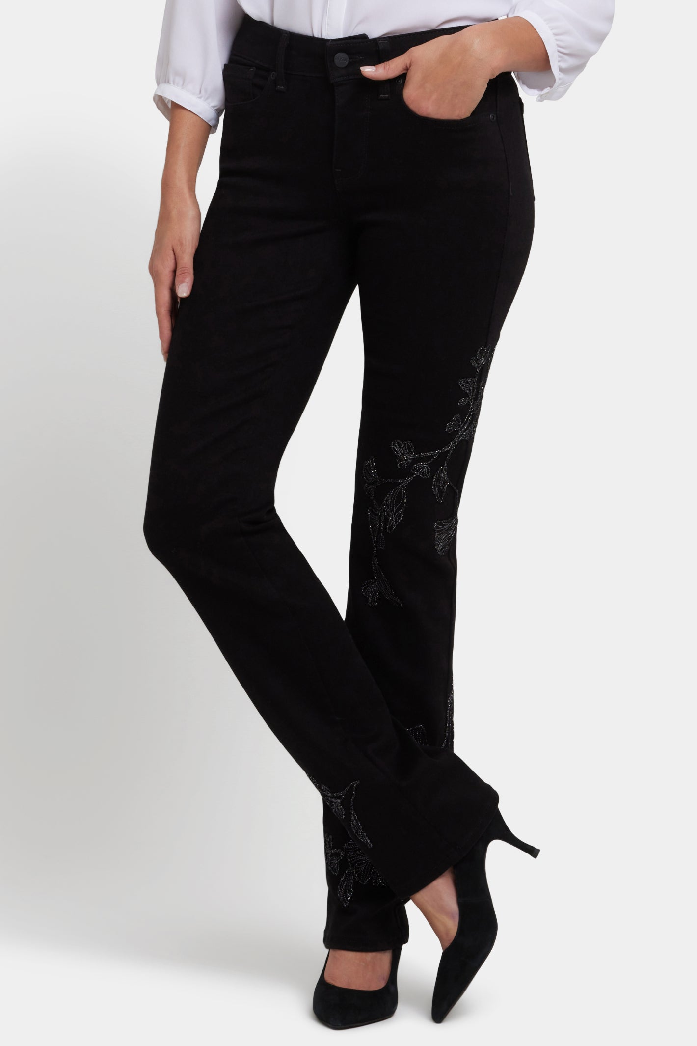 Woman wearing NYDJ Marilyn Straight Black Jeans 32” with subtle floral embroidery, shop NYDJ at Dotique.