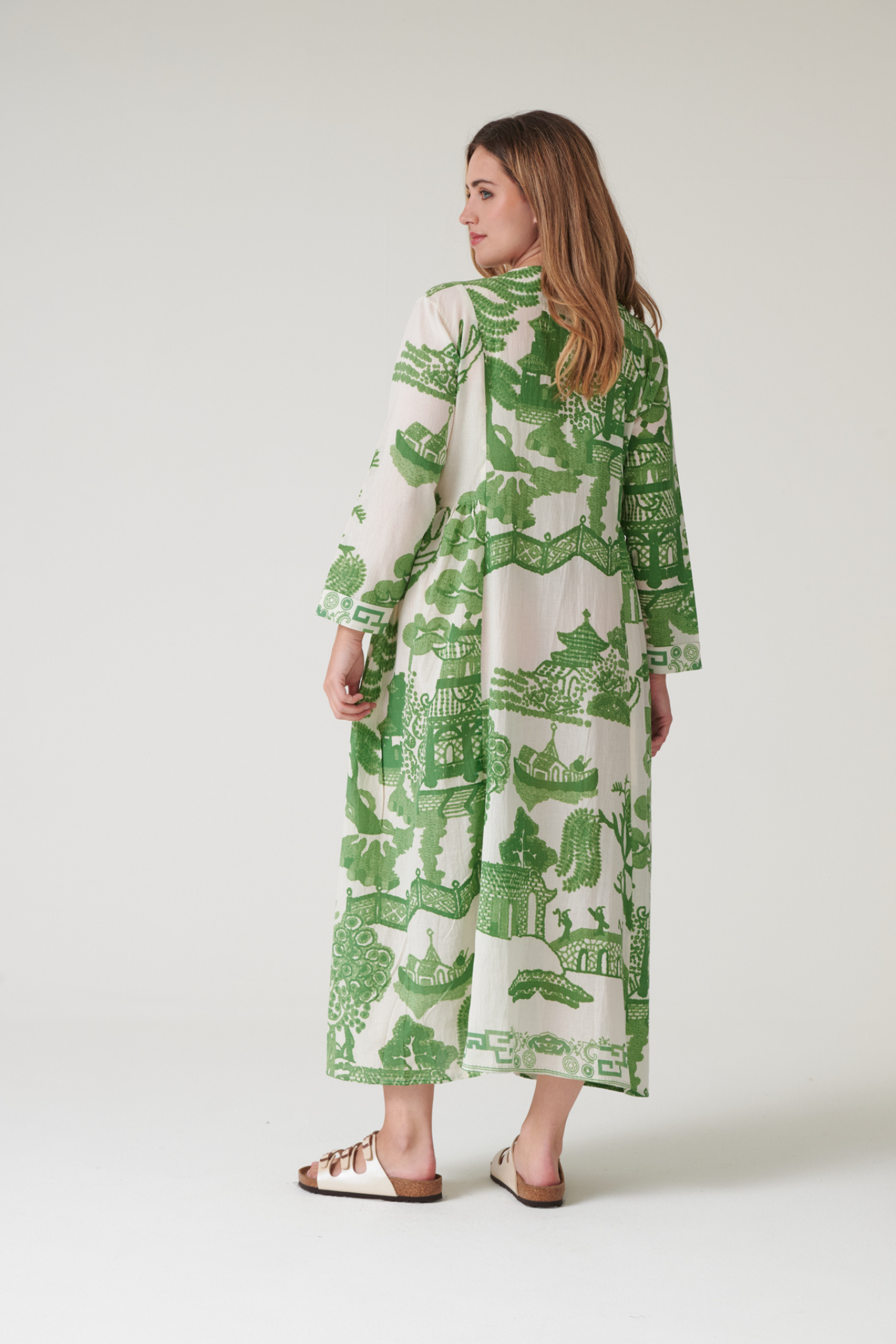Green Willow maxi dress by One Hundred Stars with pinch pleat detail and pockets. Made from 100% organic cotton, perfect for summer days and warm-weather wardrobes.