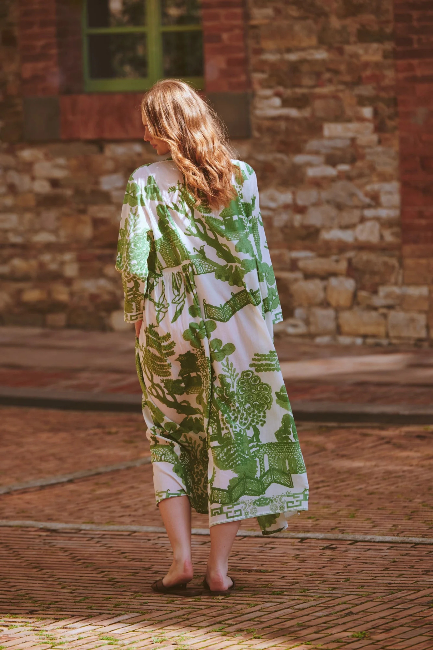 Green Willow maxi dress by One Hundred Stars with pinch pleat detail and pockets. Made from 100% organic cotton, perfect for summer days and warm-weather wardrobes.