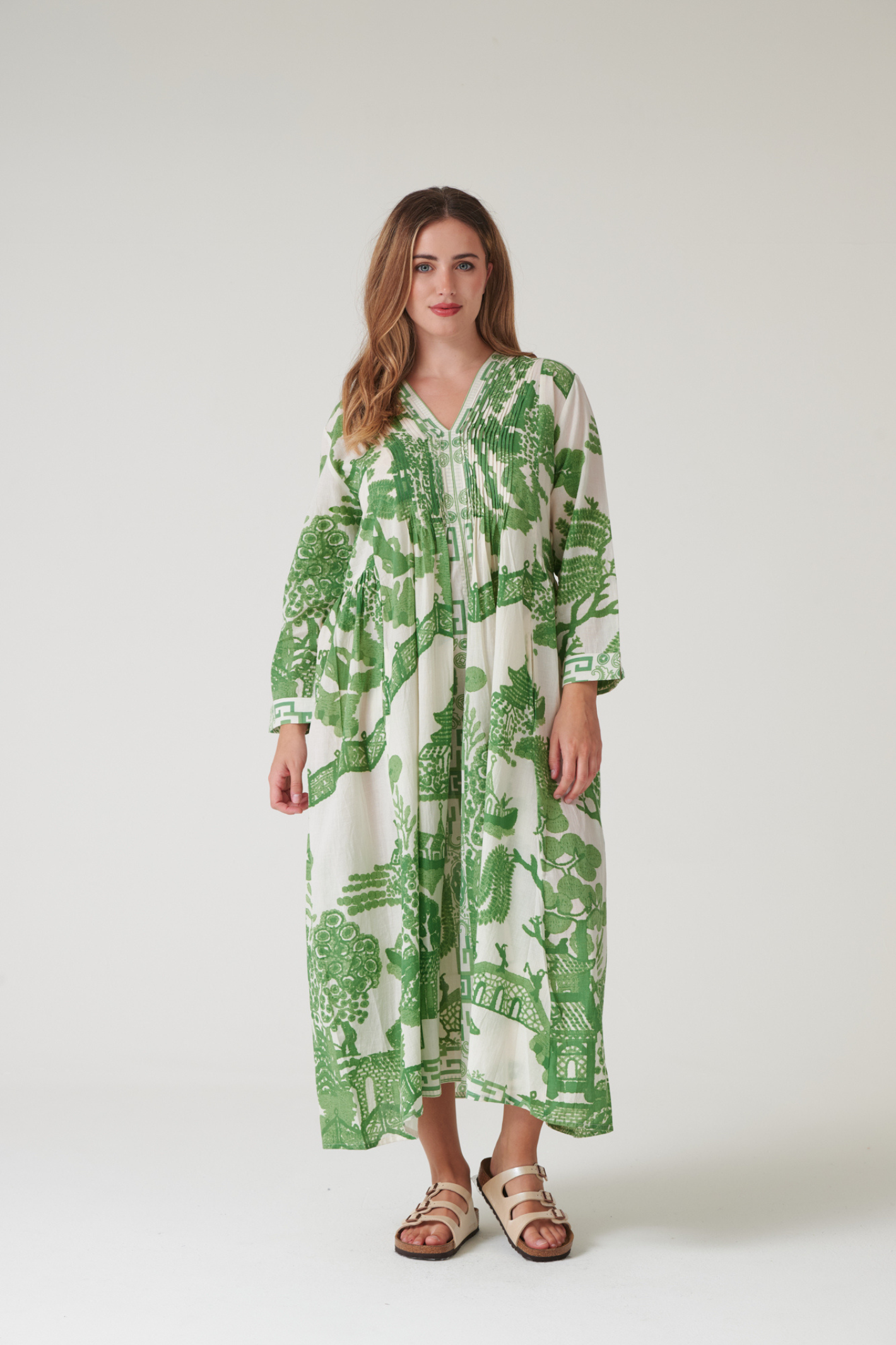 Green Willow maxi dress by One Hundred Stars with pinch pleat detail and pockets. Made from 100% organic cotton, perfect for summer days and warm-weather wardrobes.