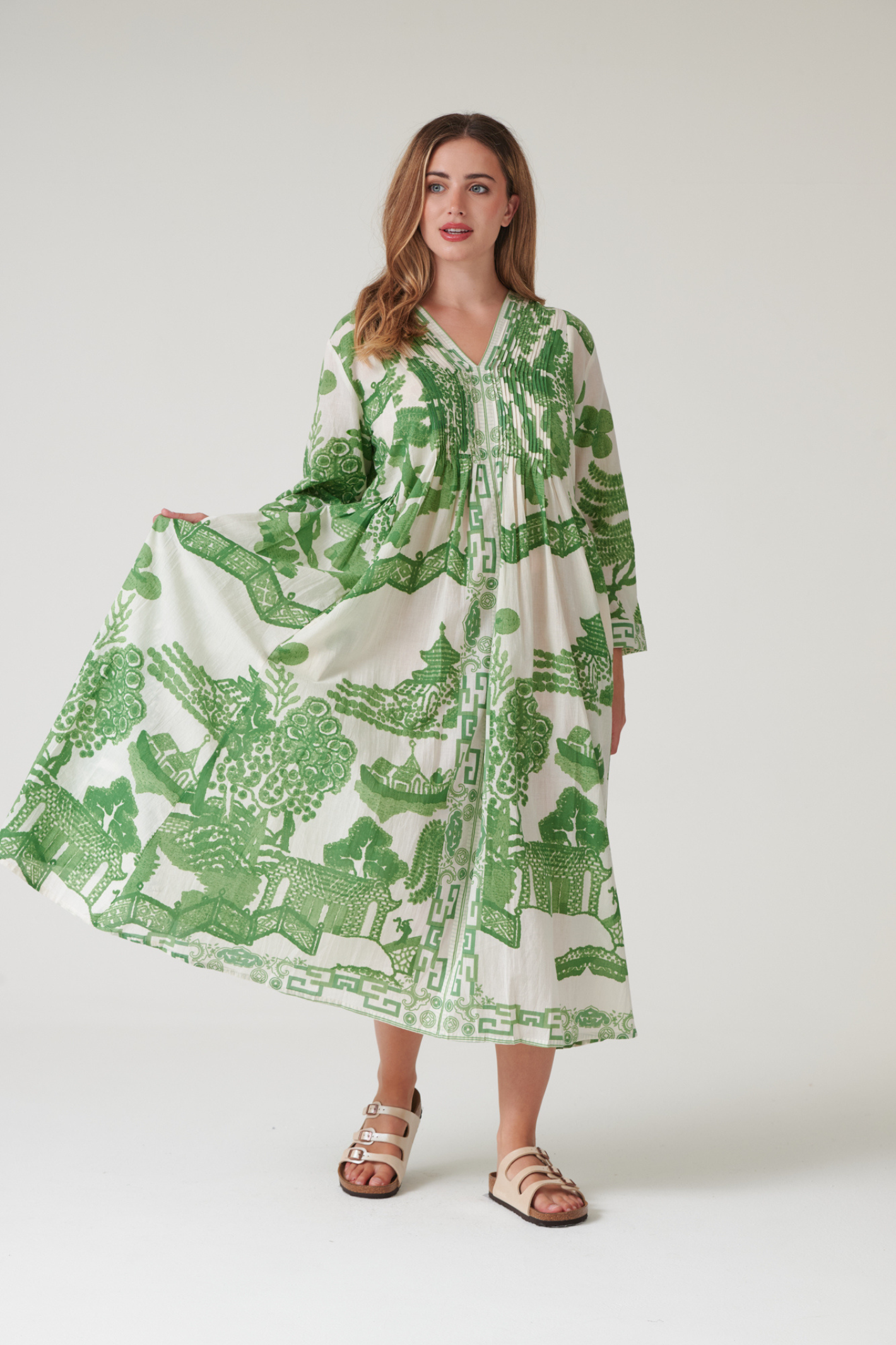 Green Willow maxi dress by One Hundred Stars with pinch pleat detail and pockets. Made from 100% organic cotton, perfect for summer days and warm-weather wardrobes.