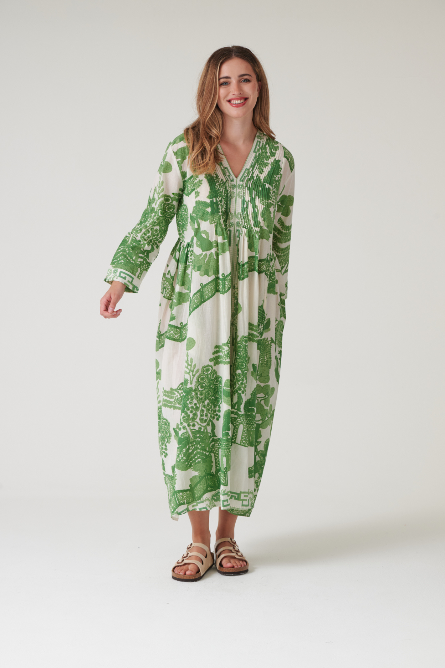 Green Willow maxi dress by One Hundred Stars with pinch pleat detail and pockets. Made from 100% organic cotton, perfect for summer days and warm-weather wardrobes.