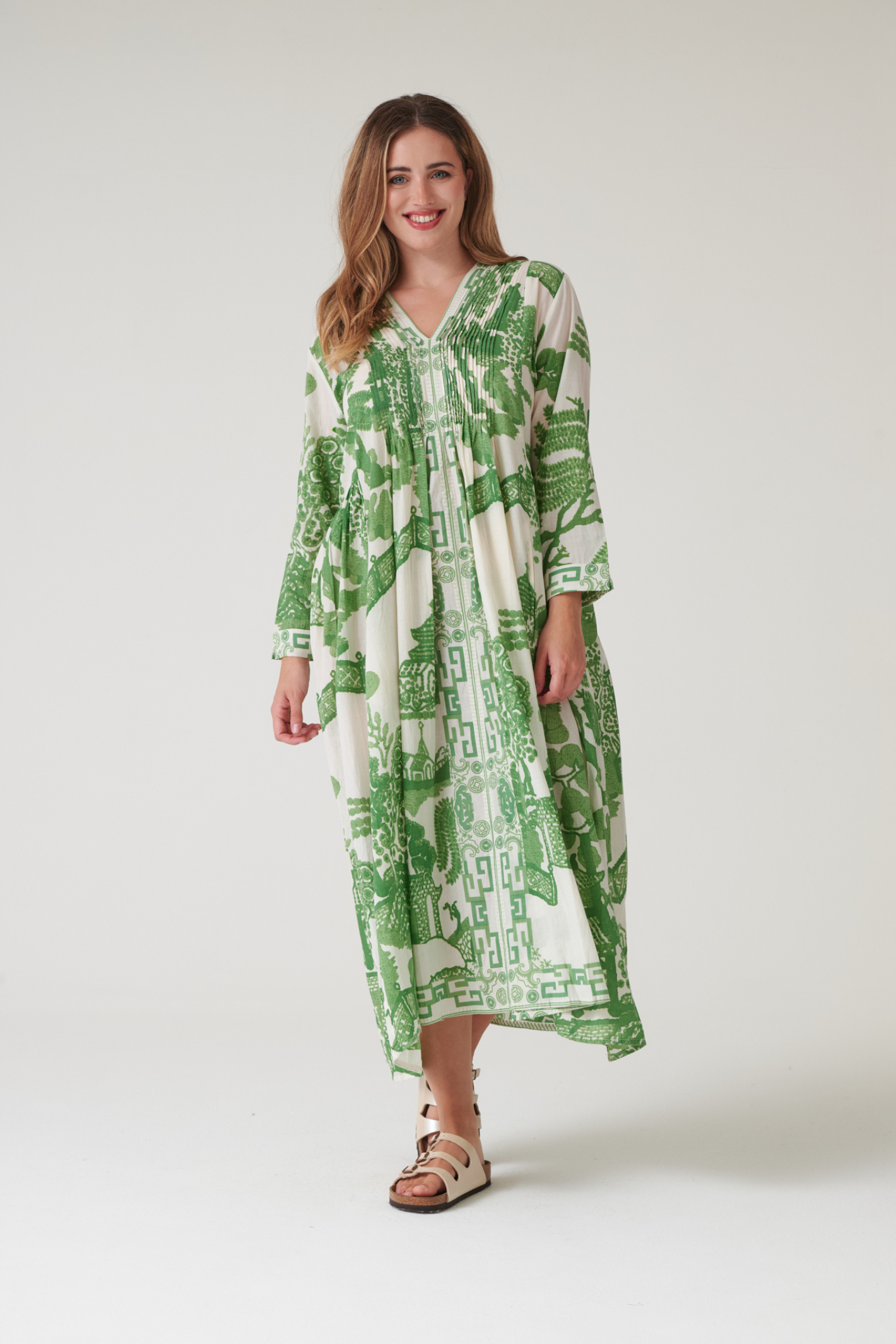 Green Willow maxi dress by One Hundred Stars with pinch pleat detail and pockets. Made from 100% organic cotton, perfect for summer days and warm-weather wardrobes.