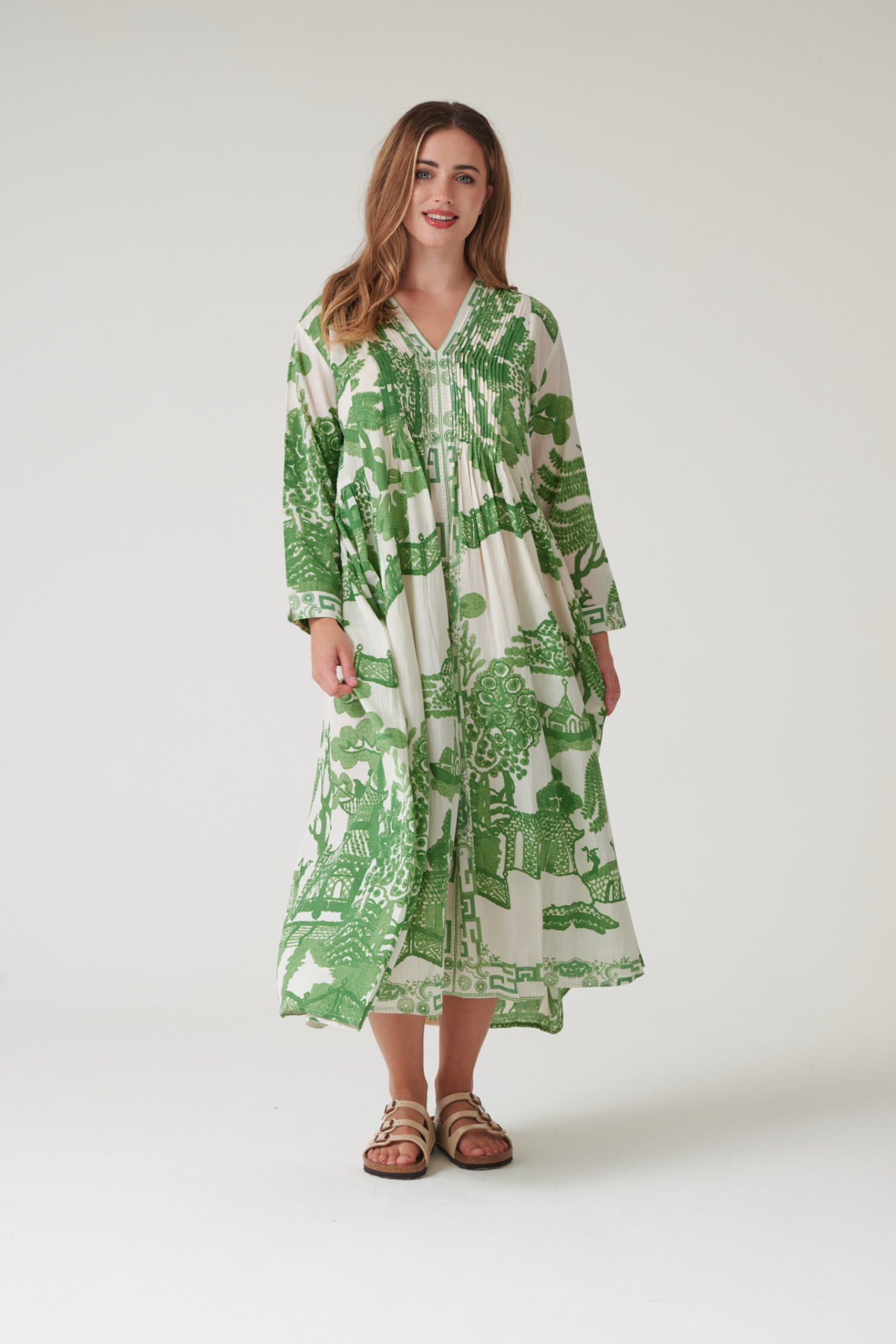 Green Willow maxi dress by One Hundred Stars with pinch pleat detail and pockets. Made from 100% organic cotton, perfect for summer days and warm-weather wardrobes.