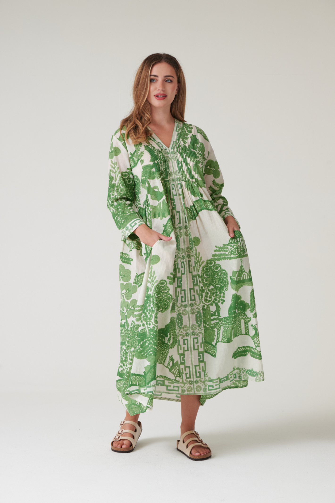 Green Willow maxi dress by One Hundred Stars with pinch pleat detail and pockets. Made from 100% organic cotton, perfect for summer days and warm-weather wardrobes.