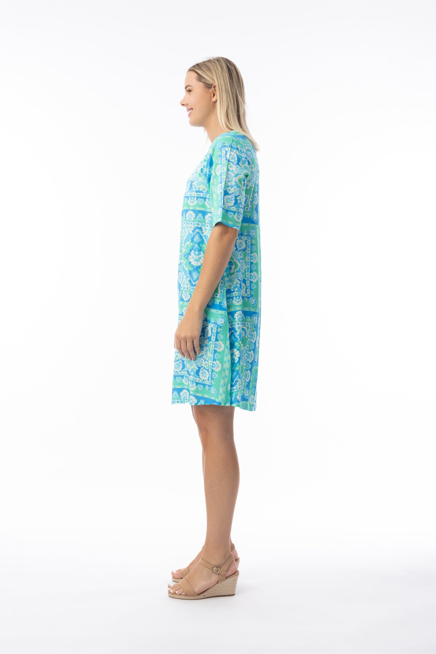 Side profile of model wearing Orientique 10073 Montevideo Dress Aqua by orientique, shop orientique at Dotique