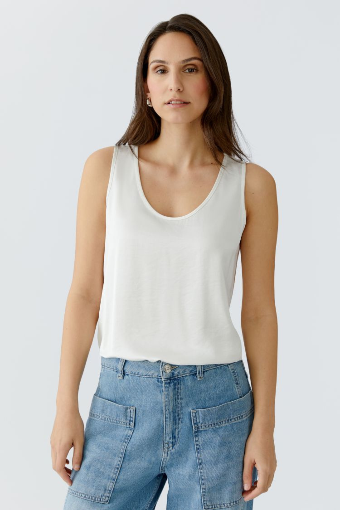 Sleeveless scoop neck top by Oui in soft, fluid fabric. An easy layering essential that works year-round. Available in multiple colours at Dotique.