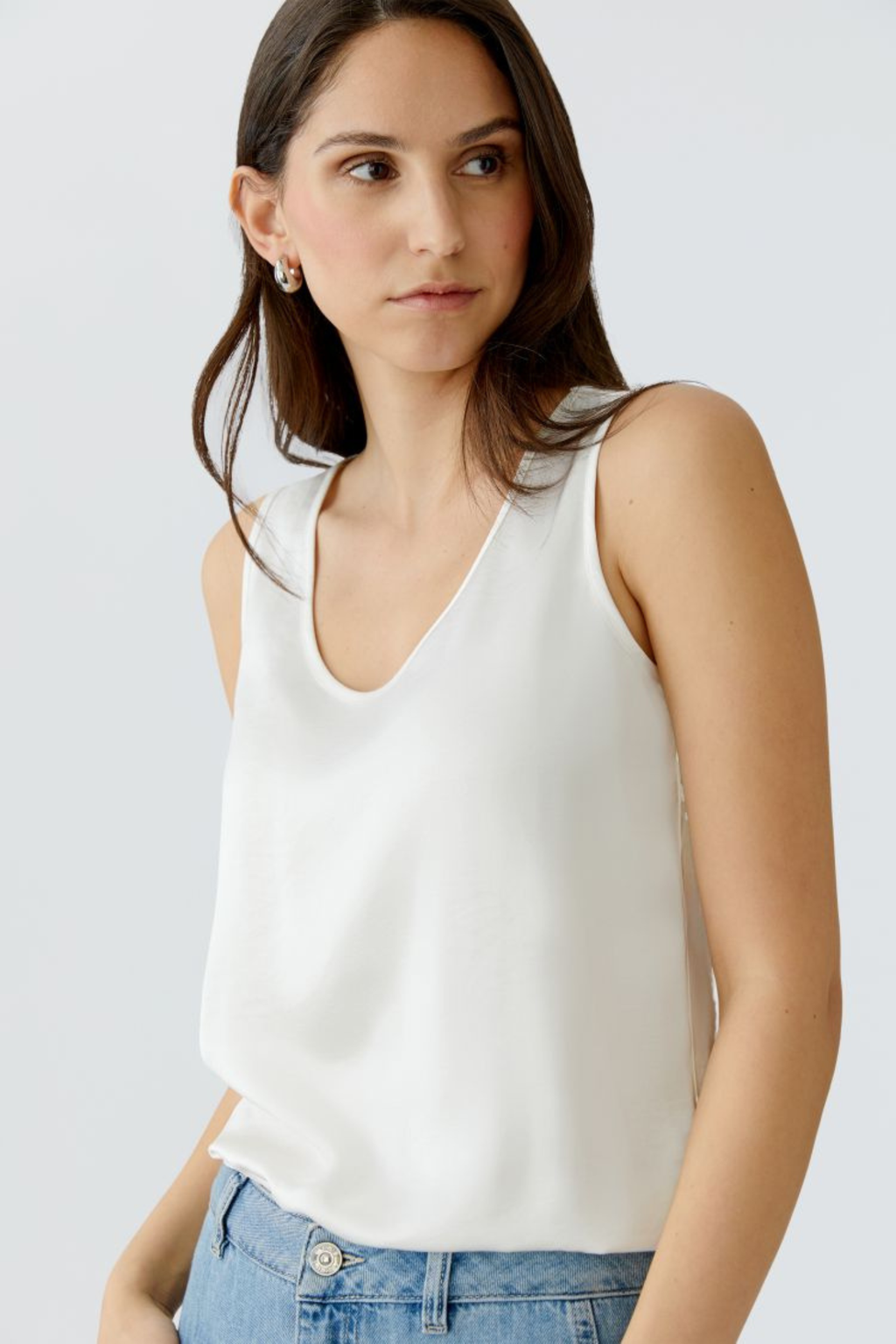 Sleeveless scoop neck top by Oui in soft, fluid fabric. An easy layering essential that works year-round. Available in multiple colours at Dotique.