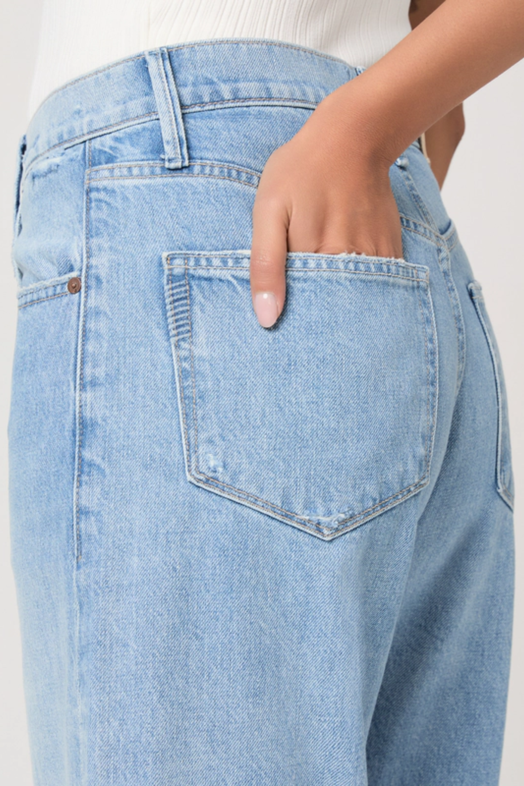 Close-up of light denim Paige Arellia Ankle Barrel Leg Jeans - Fauve by PAIGE with hand in back pocket, shop PAIGE at Dotique.