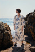 Woman standing by rocky shore wearing Part Two 30310448 AlyaPW Blue Shadow Flower Print Dress by Part Two Shop Part Two at Dotique