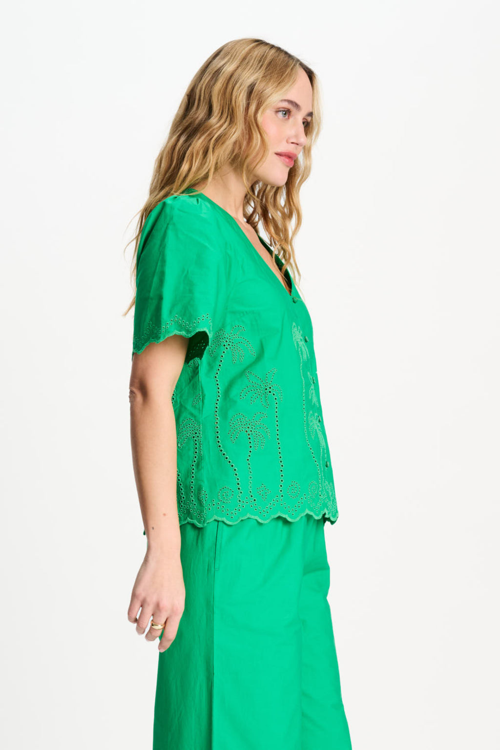 Side view of woman in Pom Amsterdam SP9544 Broderie Anglaise Palm Green Organic Cotton Blouse, shop Pom Amsterdam at Dotique