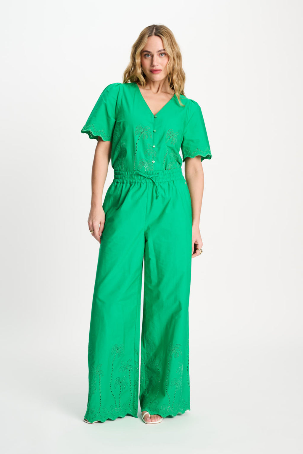 Model showcasing Pom Amsterdam SP9565 Broderie Anglaise Palm Green Organic Cotton Trousers by Pom Amsterdam, shop Dotique online