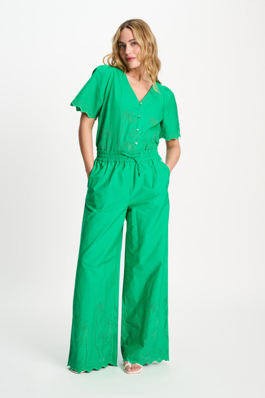 Woman wearing Pom Amsterdam SP9565 Broderie Anglaise Palm Green Organic Cotton Trousers by Pom Amsterdam, shop Dotique