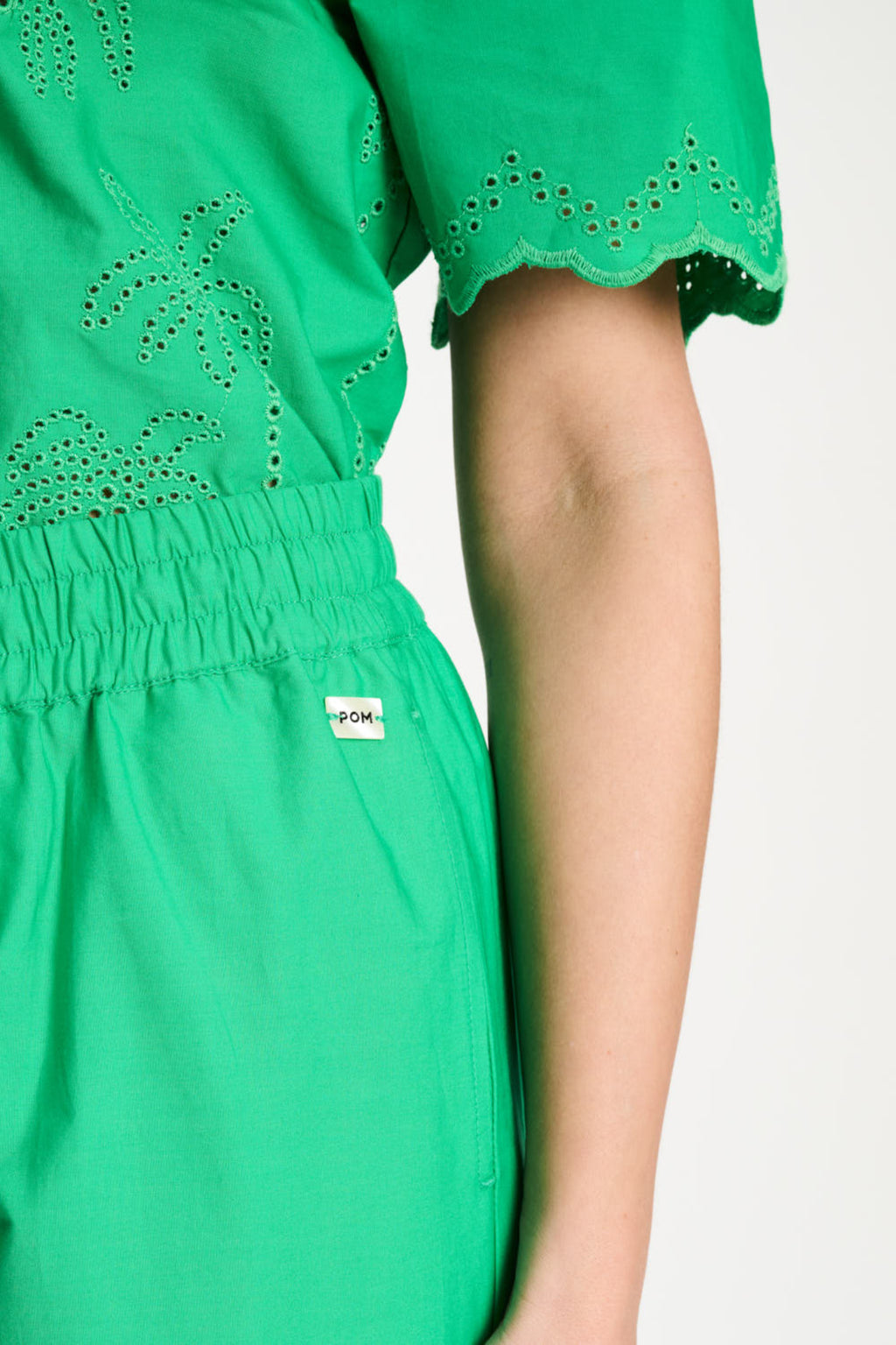 Close-up of Pom Amsterdam SP9565 Broderie Anglaise Palm Green Organic Cotton Trousers by Pom Amsterdam, shop Dotique online.