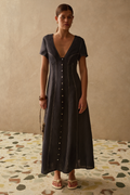 Sancia Greta Dress in navy with flattering V neckline, button front and flowing skirt. Lightweight cupro fabric. Shop now at Dotique.