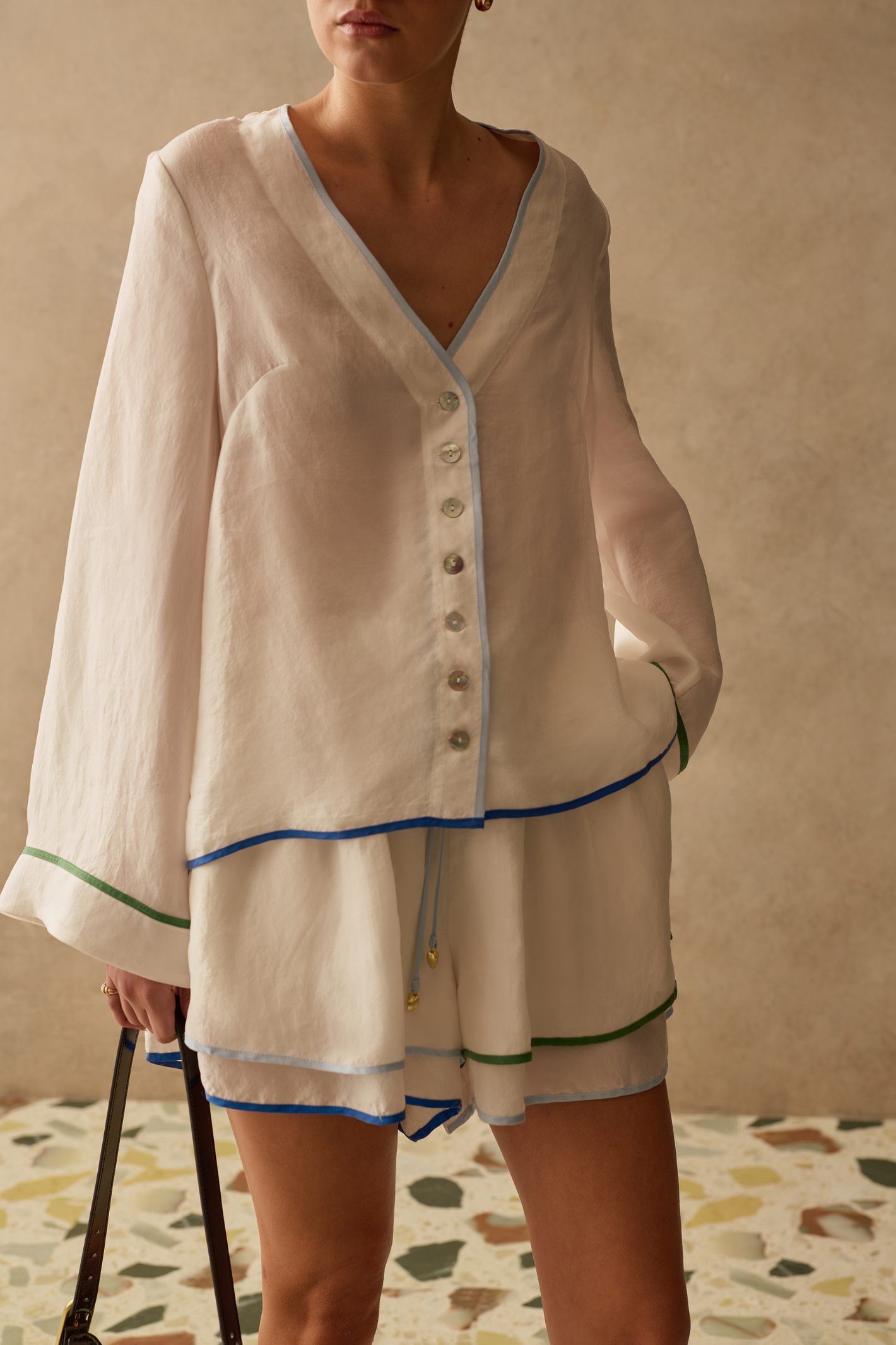 Relaxed, lightweight cupro shirt by Sancia with wide sleeves and shell buttons. Soft, floaty and easy to style for summer. Shop at Dotique.