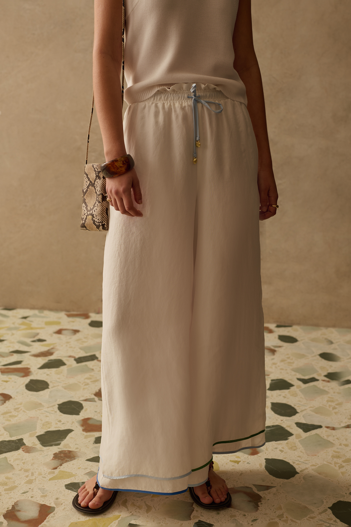 Wide leg cupro trousers by Sancia with elasticated waist and drawstring detail. Lightweight, fluid and easy to style. Shop at Dotique.