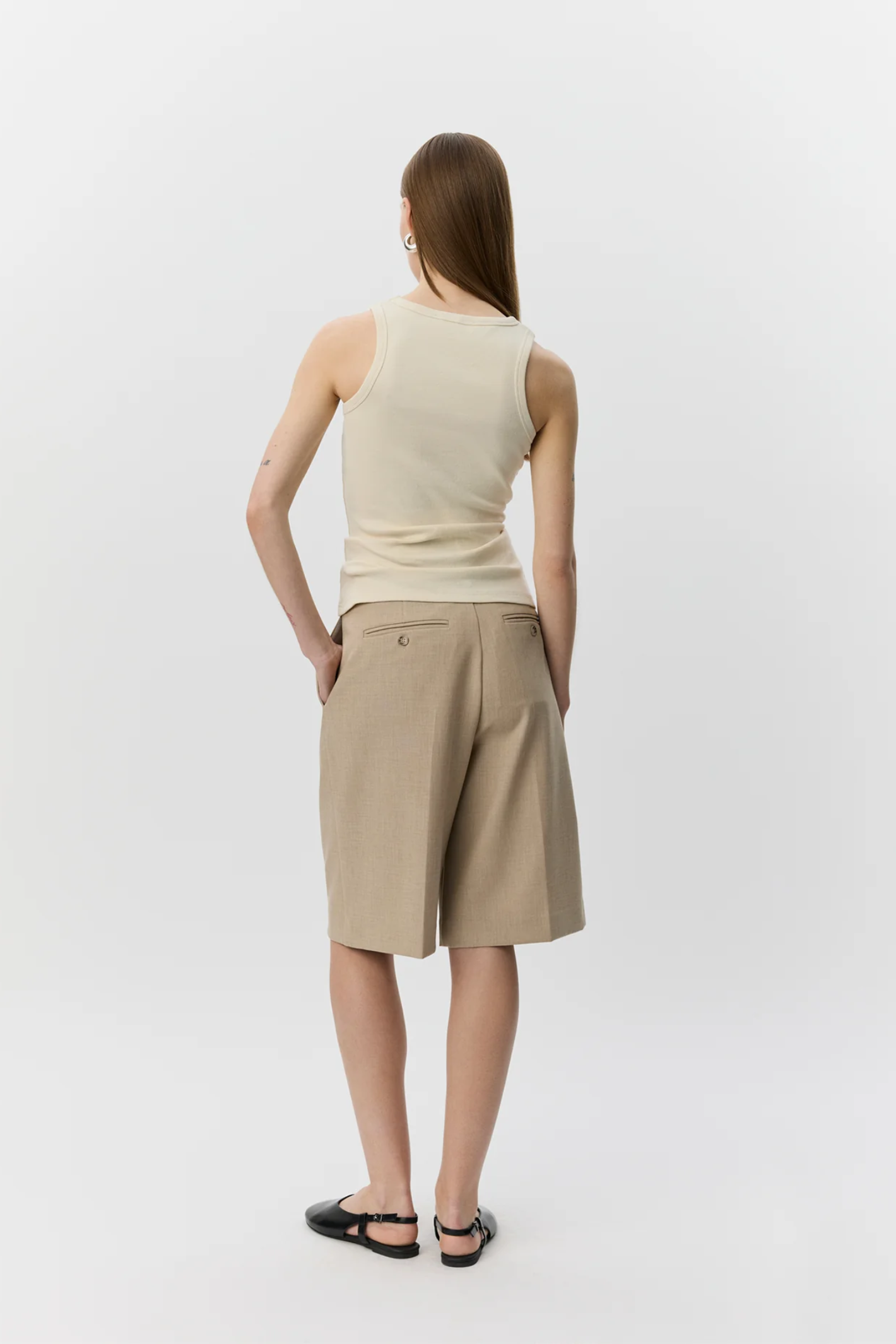 Model wearing Sofie Schnoor Becasw Rib Tank Top Cream White S262362 by Sofie Schnoor shop Dotique from the back view
