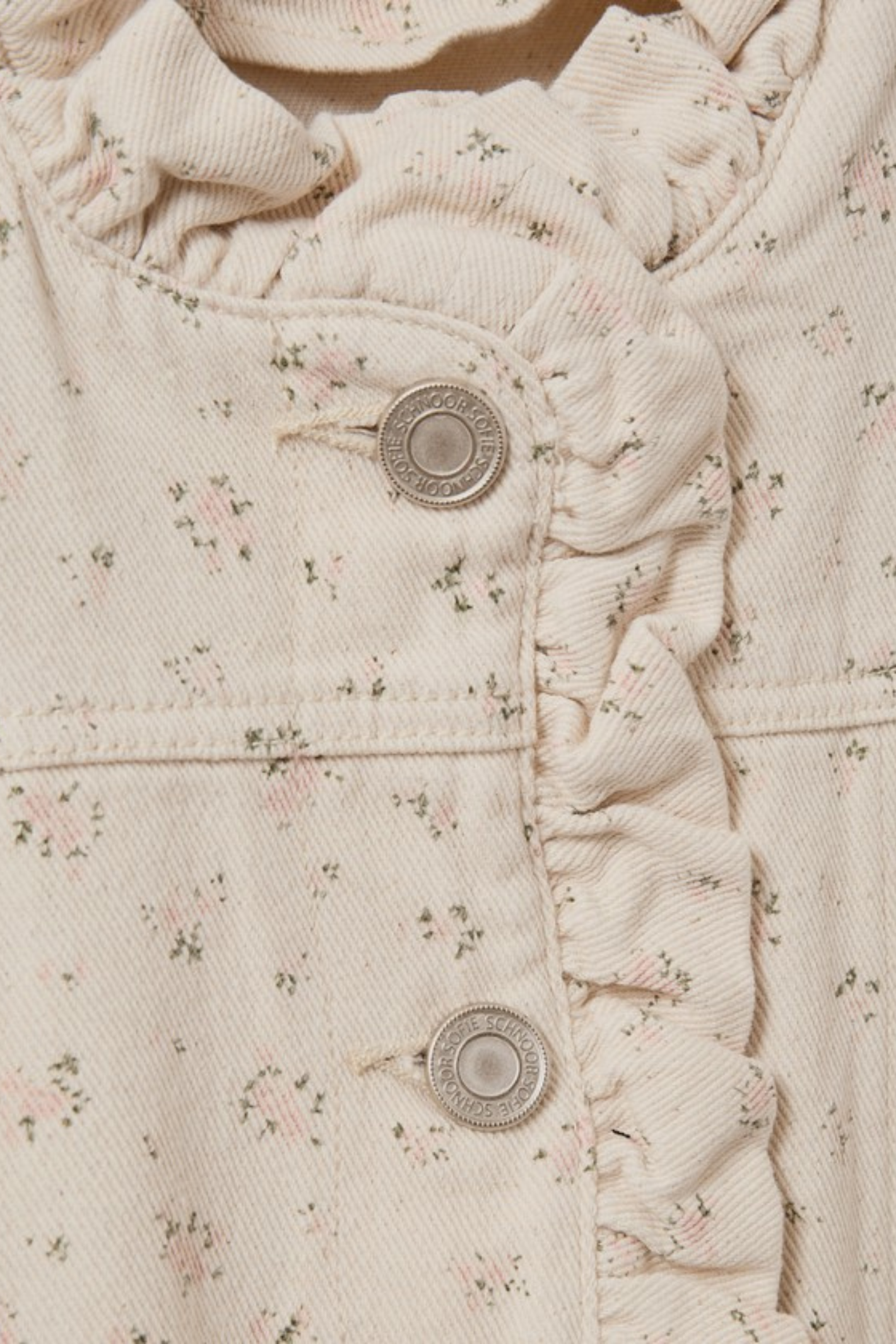 Close-up of floral fabric and branded buttons on Sofie Schnoor S261215 Farahsw Frill Sleeve Gilet – Rose Flower, shop Sofie Schnoor at Dotique