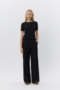 Model wearing Sofie Schnoor SNOS414 Nataliasw T‑shirt – Black by Sofie Schnoor shop at Dotique