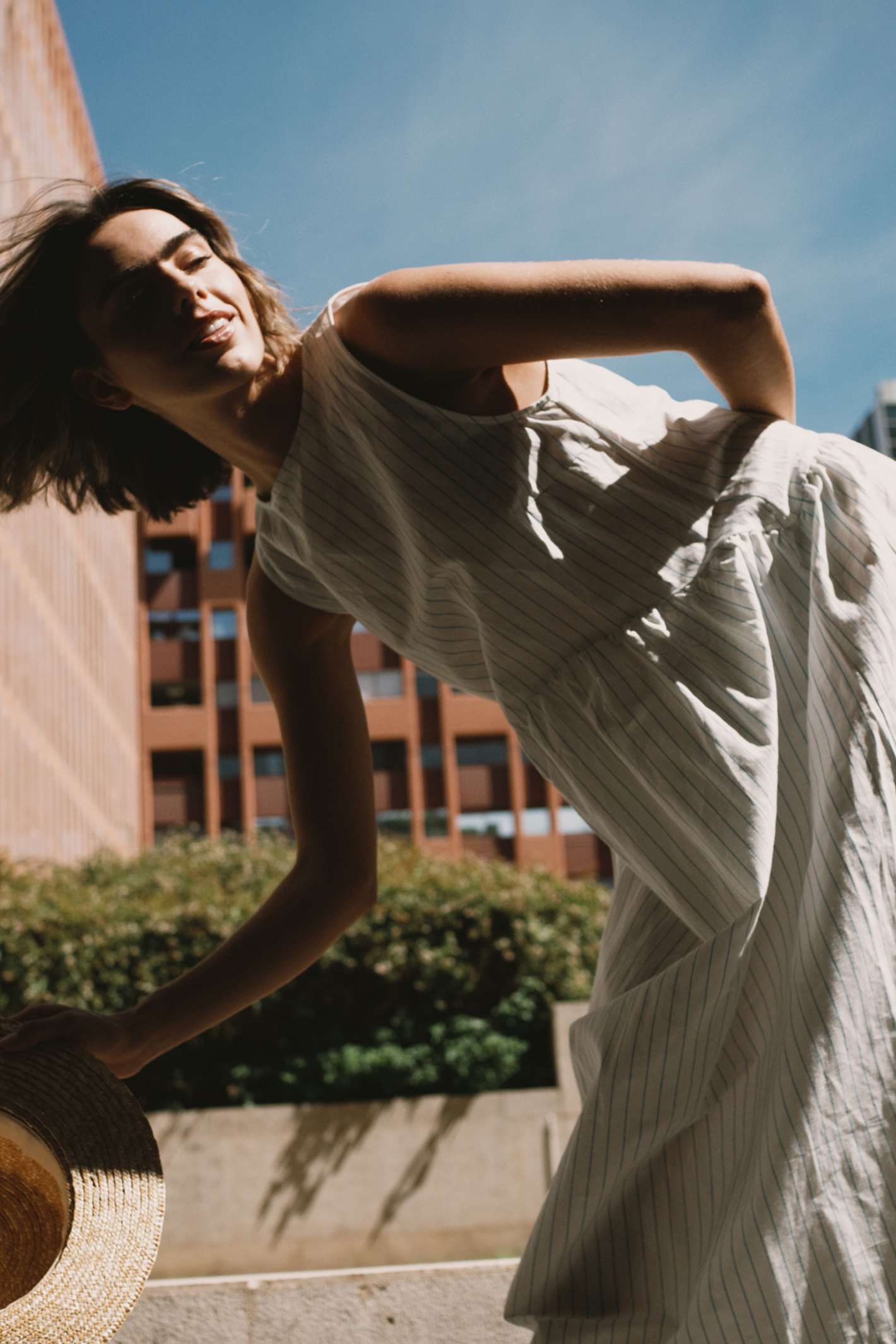 Tiny Big Sister striped cotton dress with a low back detail and relaxed summer fit. Light, flattering and easy to wear. Shop at Dotique.