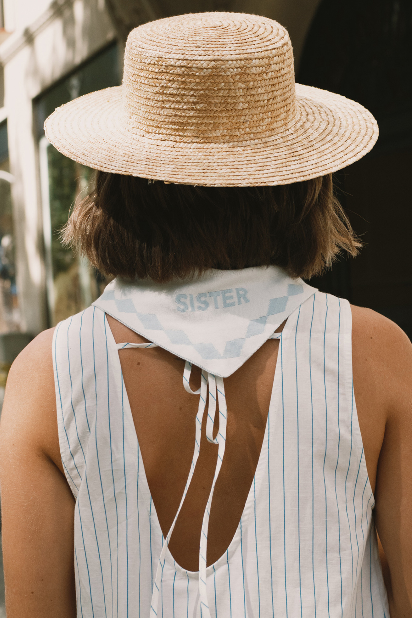 Tiny Big Sister striped cotton dress with a low back detail and relaxed summer fit. Light, flattering and easy to wear. Shop at Dotique.