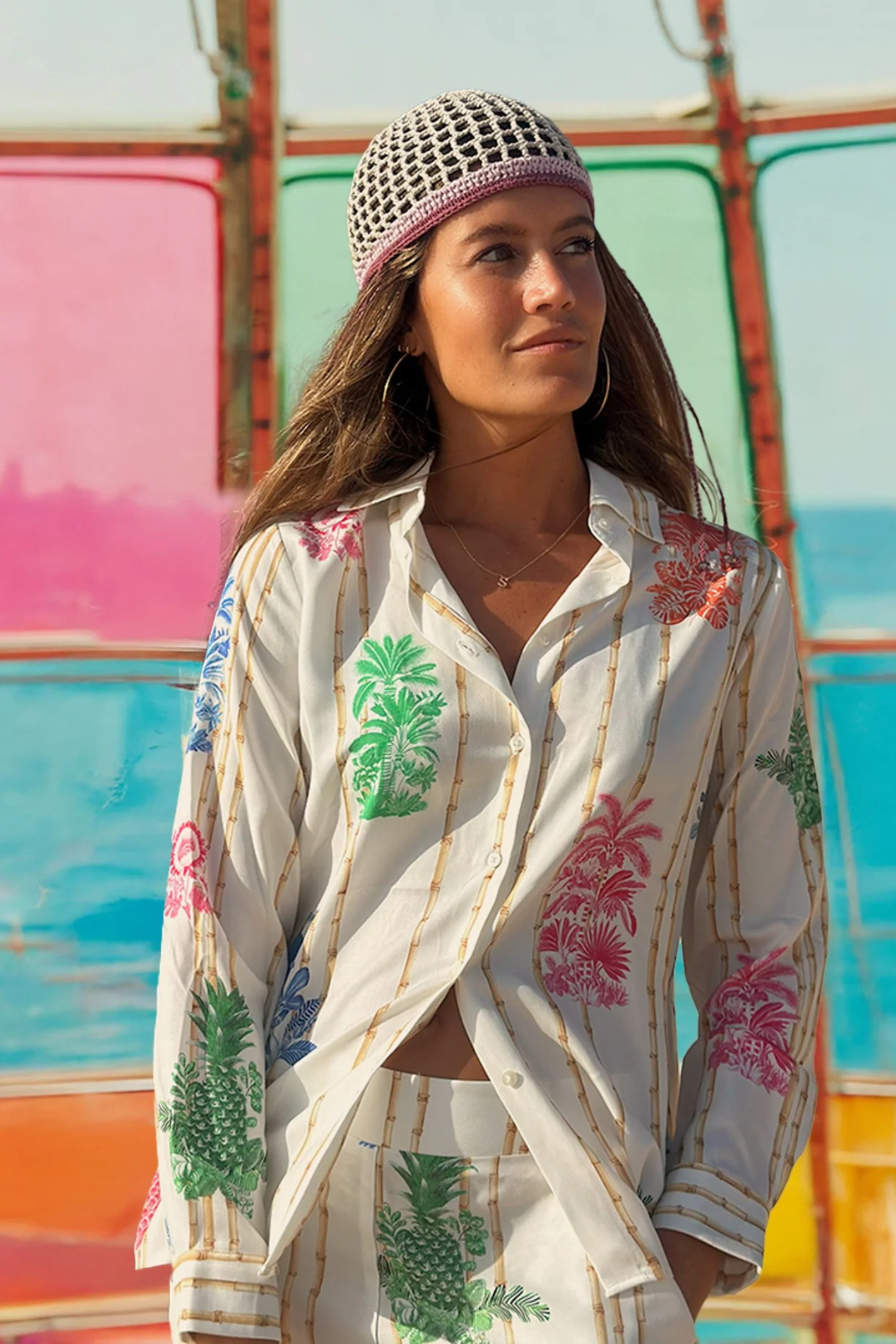 Noella white shirt and trousers with multicolor botanical prints styled with crochet cap gallery position 1 Shop Noella at Dotique