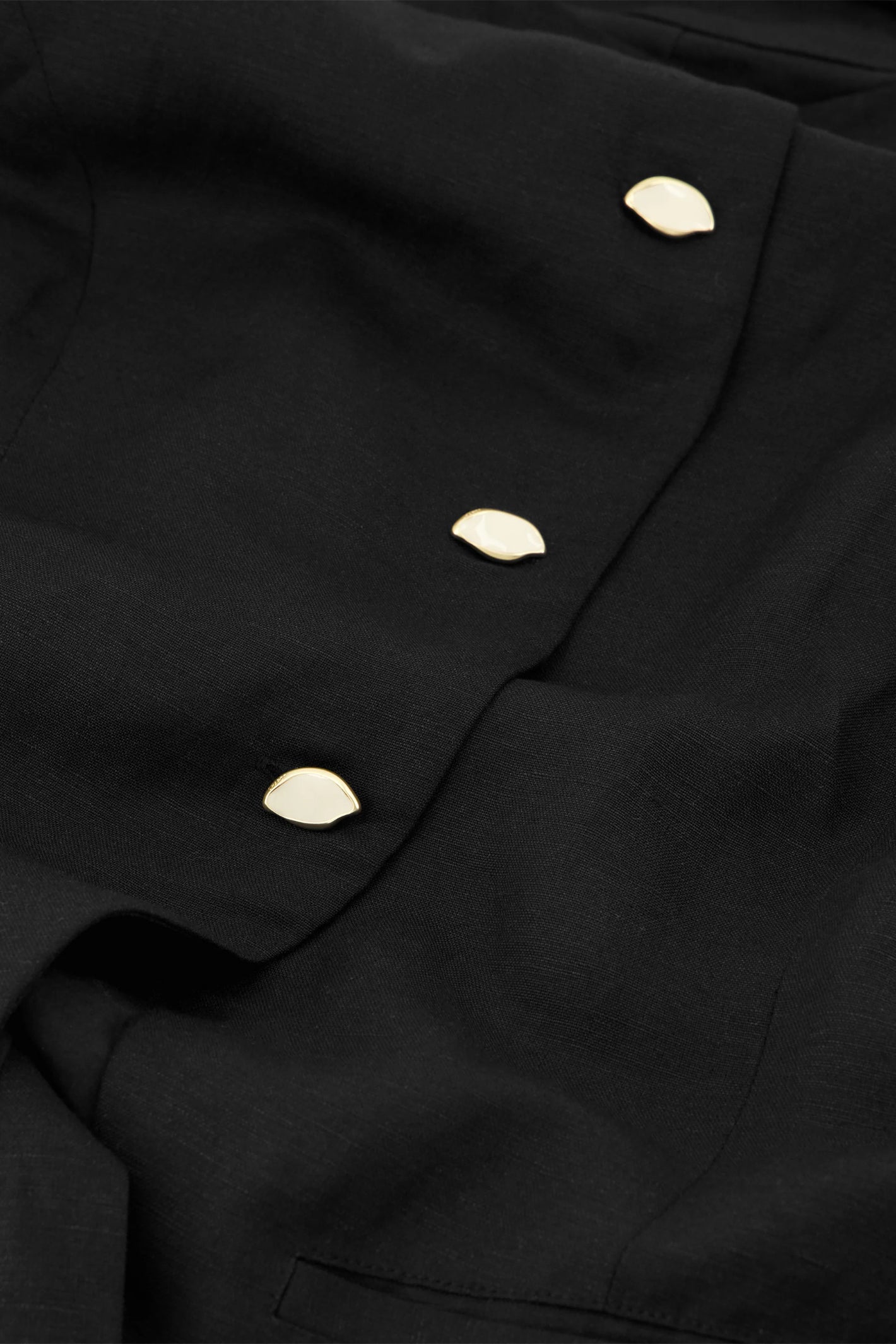 Close-up of gold buttons on Fabienne Chapot Mercy Top Black by Fabienne Chapot, shop Fabienne Chapot at Dotique