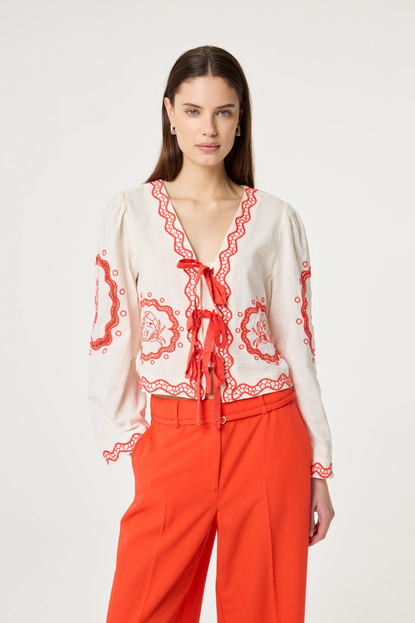Woman wearing Fabienne Chapot Serviette Blouse Cosy White/Tangerine Tango available to shop at Dotique with elegant bow ties and embroidery