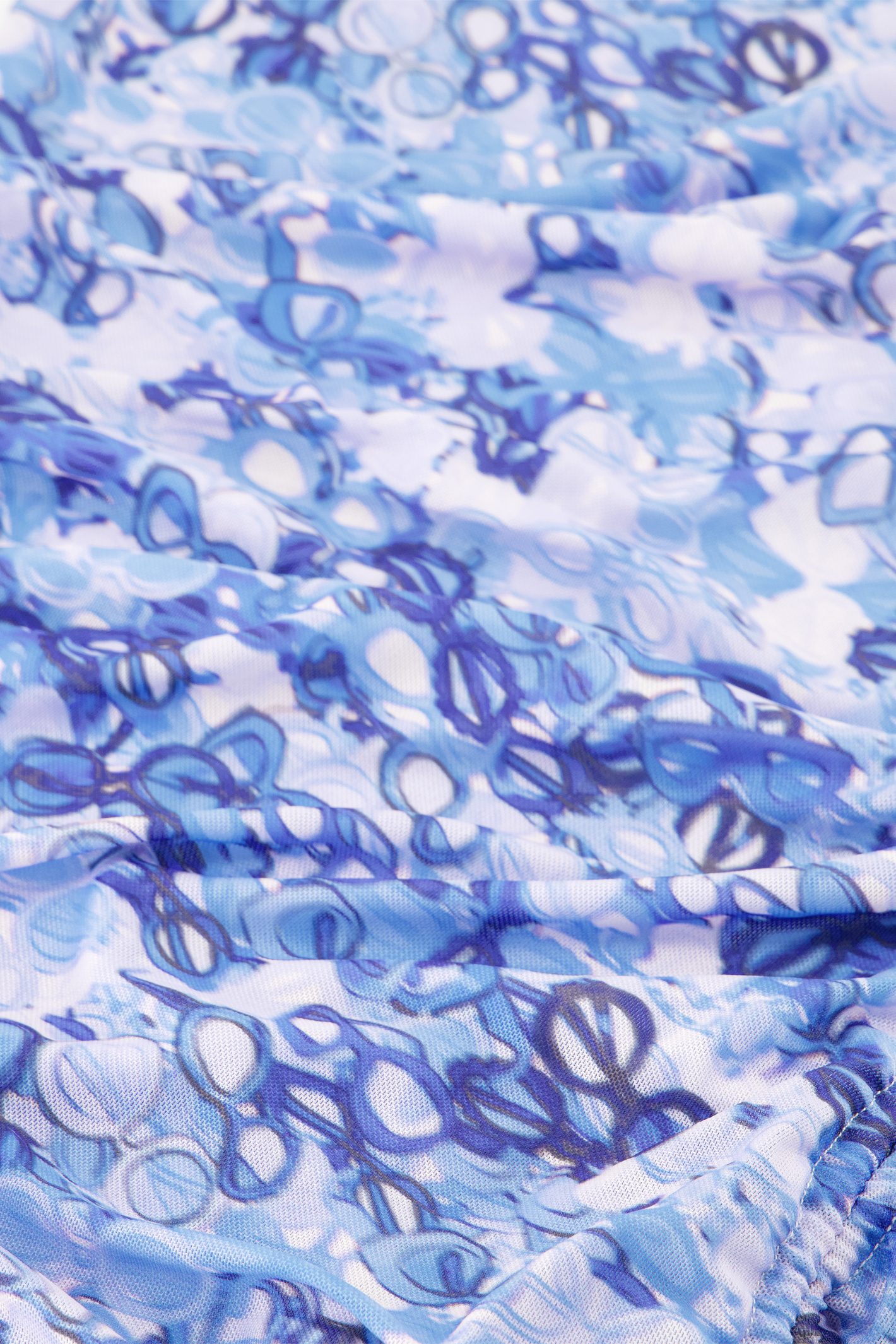 Close-up of blue textured fabric with abstract sunglasses print from Fabienne Chapot Zina Dress Sea of Sunglasses Blue, shop Fabienne Chapot at Dotique.