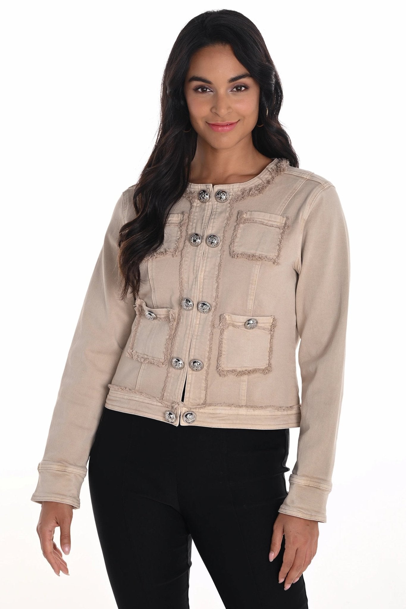 Woman wearing a beige denim jacket with button details on a white background