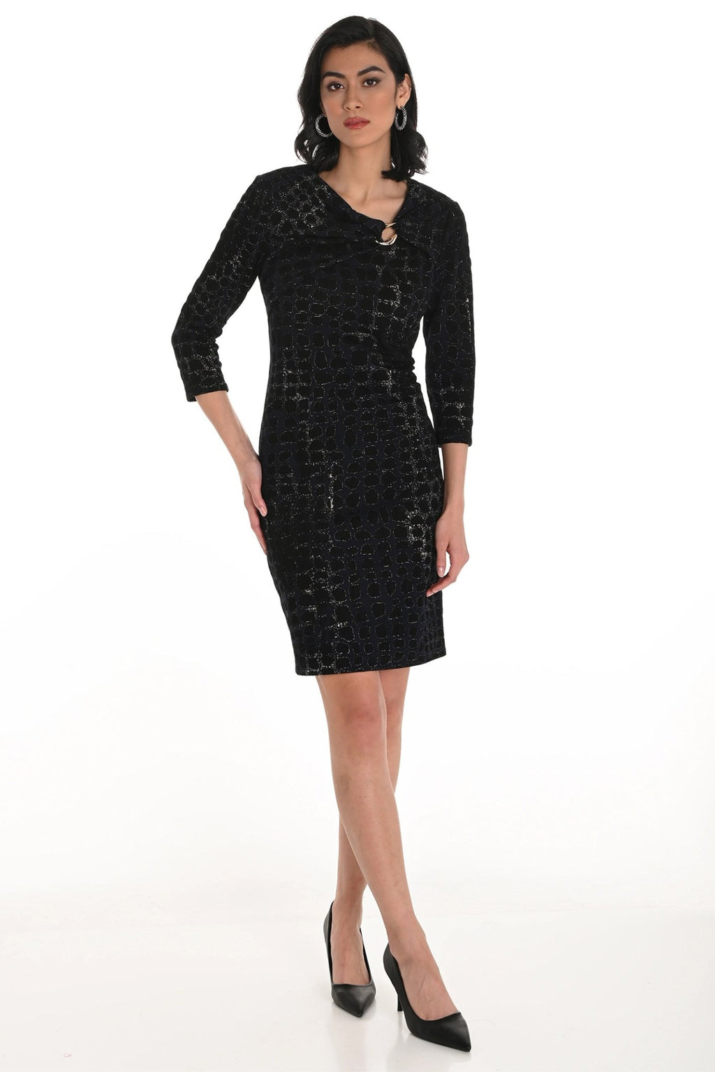 Woman wearing a black patterned dress on a white background